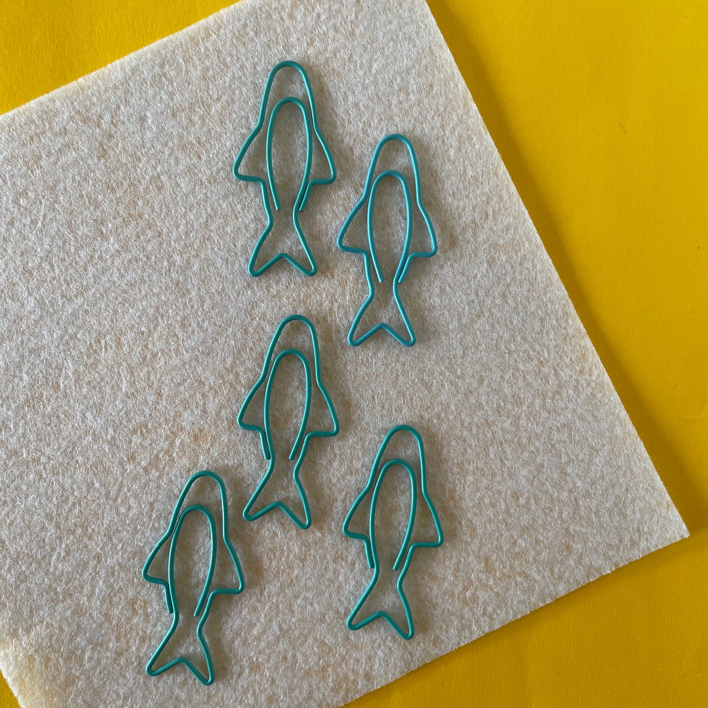 Image shows a fun set of 5 turquoise paper clips shaped like sardines