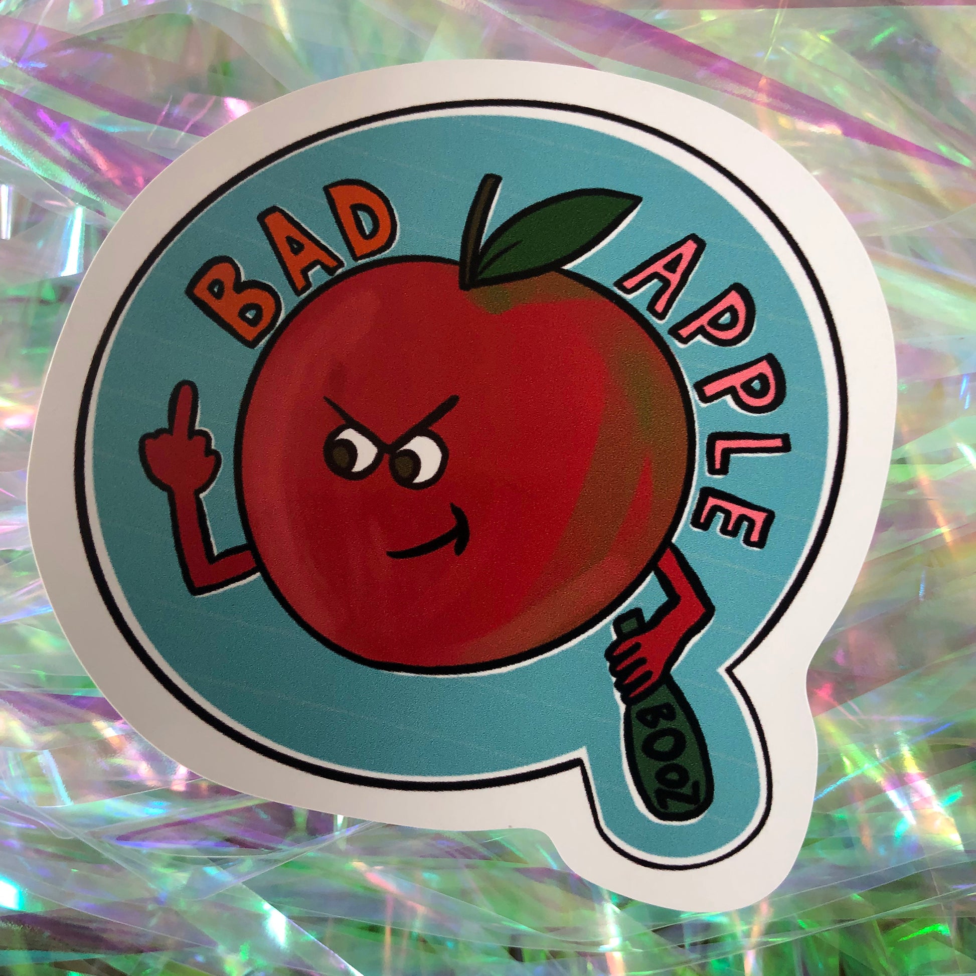 Image shows a vinyl sticker featuring a red apple swearing and drinking with the wording 'Bad Apple'