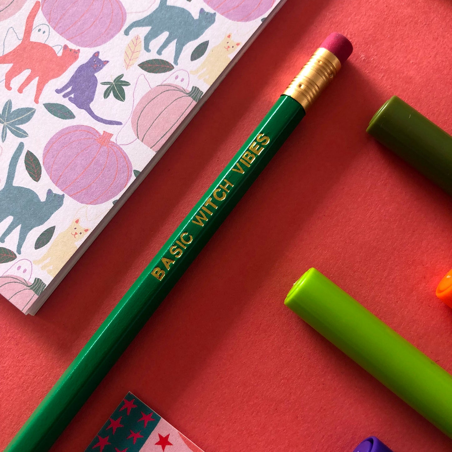 Image of a green pencil with 'Basic Witch Vibes' embossed in gold lettering