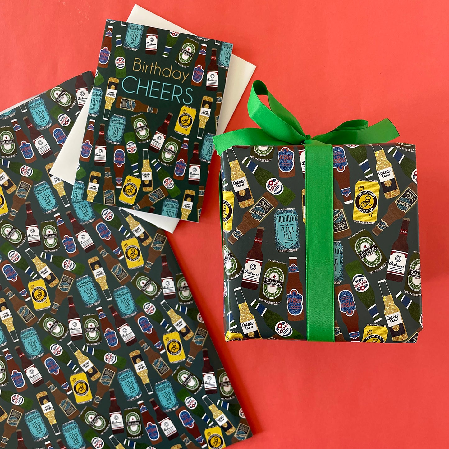Image shows a green blue gift wrap with illustrations of different beers patterned design