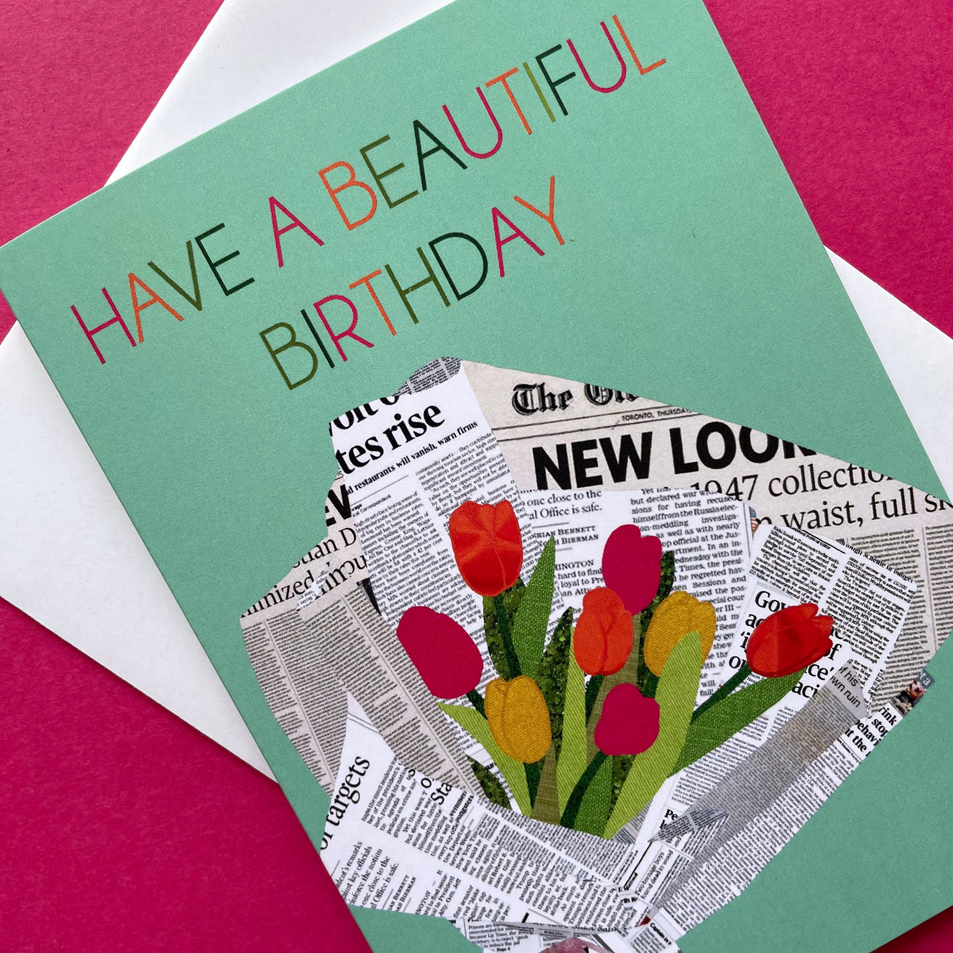 Image of a pastel green card that reads Have a Beautiful Birthday and features a unique, collaged illustration of a bouquet of tulips in newspaper.