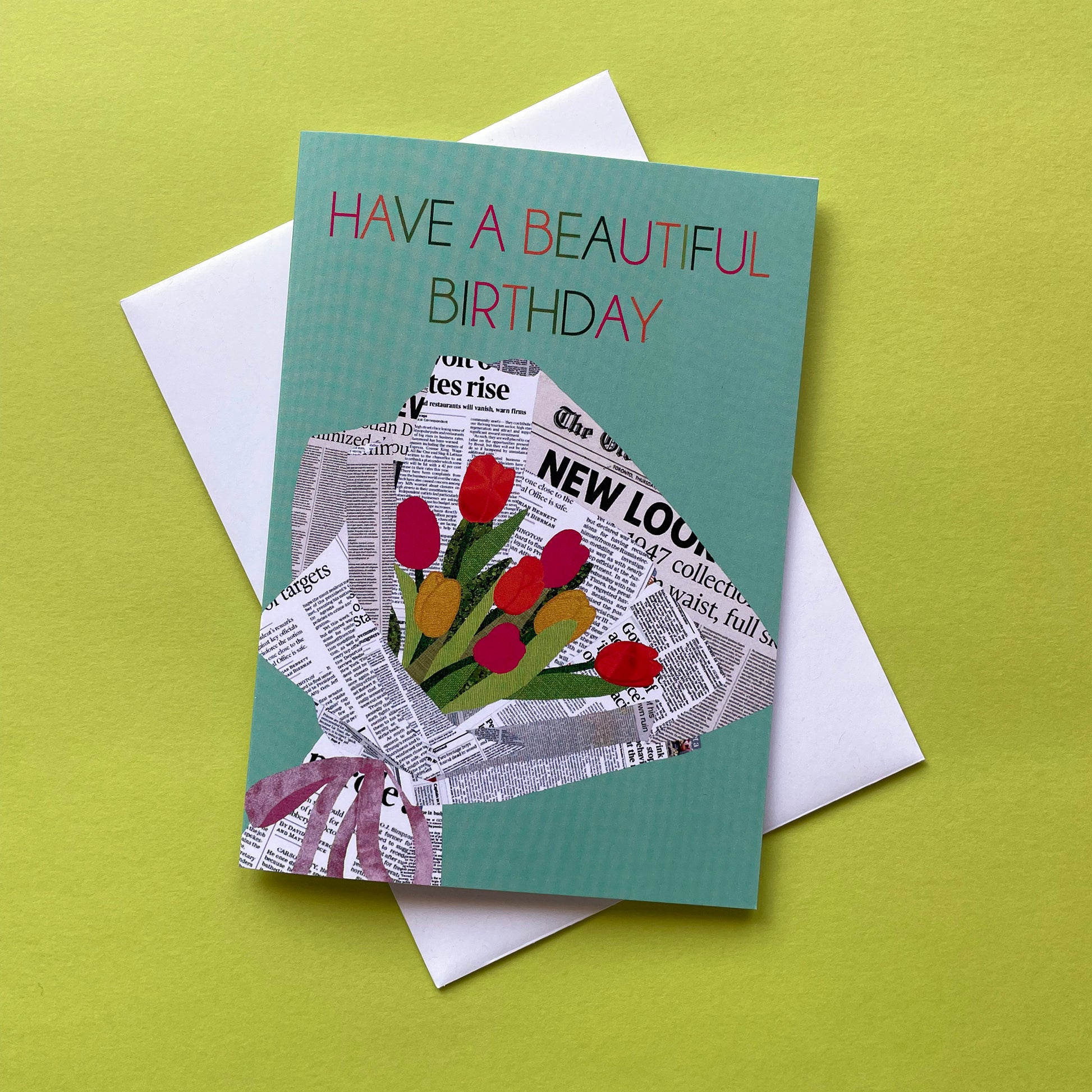 Image of a pastel green card that reads Have a Beautiful Birthday and features a unique, collaged illustration of a bouquet of tulips in newspaper.