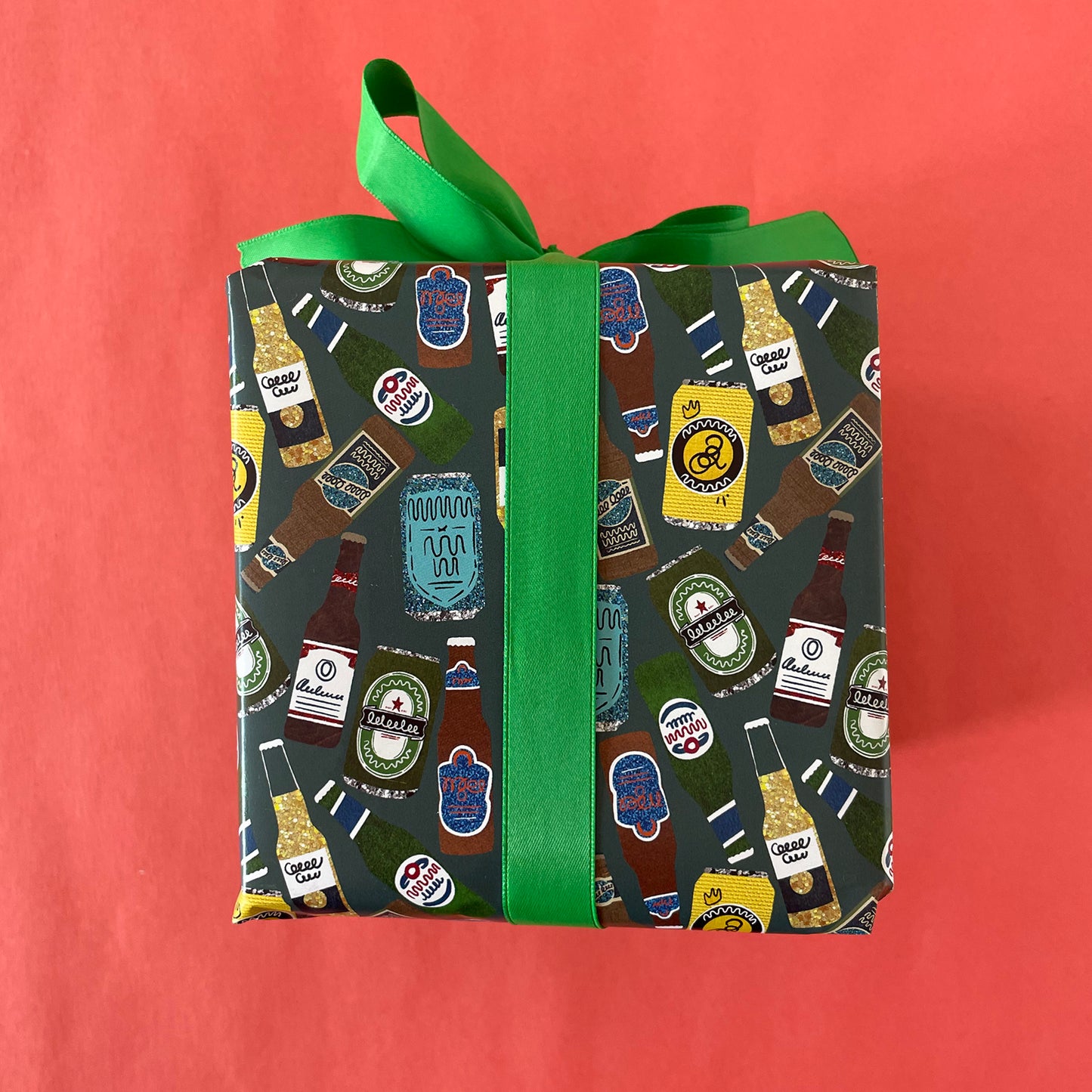 Image shows a green blue gift wrap with illustrations of different beers patterned design