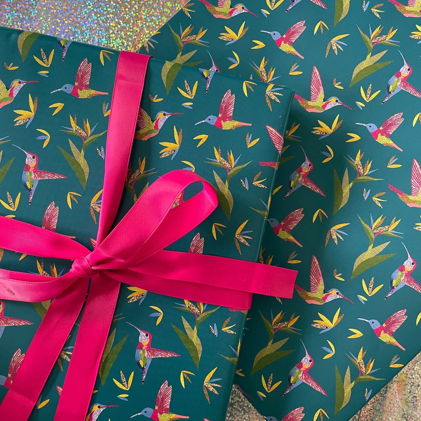 Image shows a beautiful bird paradise gift wrap featuring a stylish hummingbird and plant design.