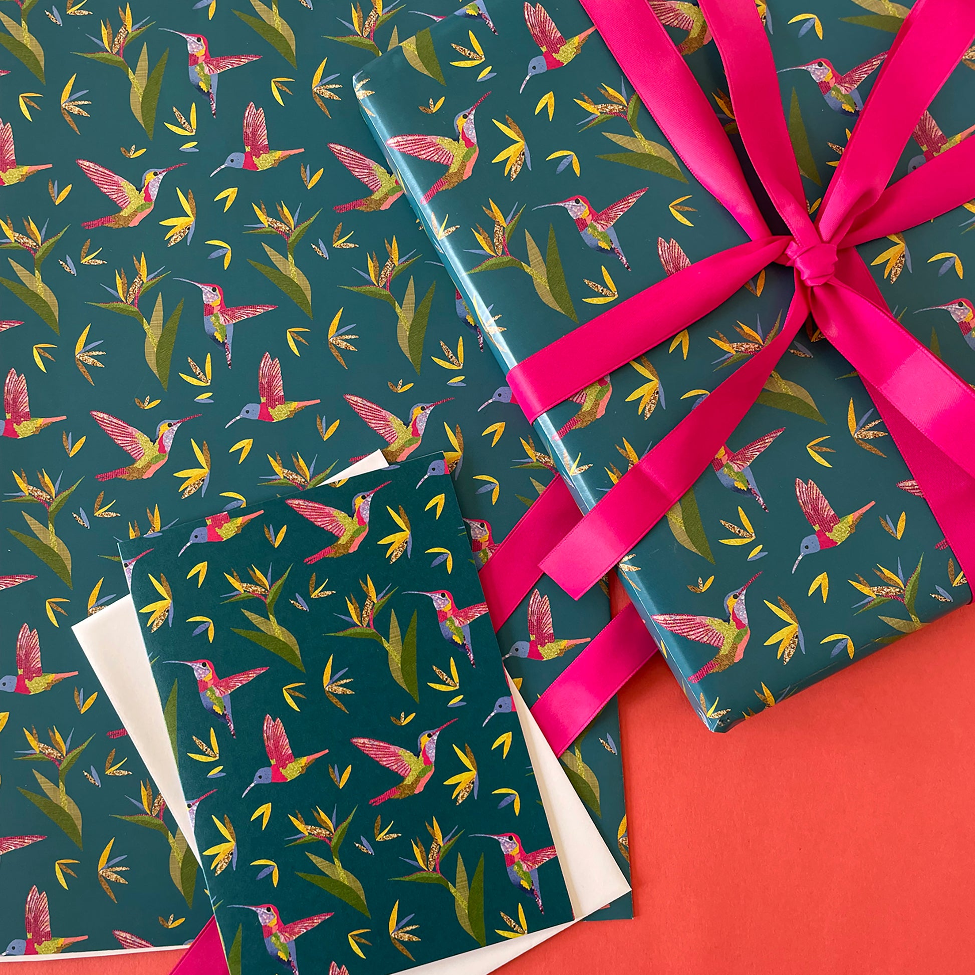 Image shows a beautiful bird paradise gift wrap featuring a stylish hummingbird and plant design.