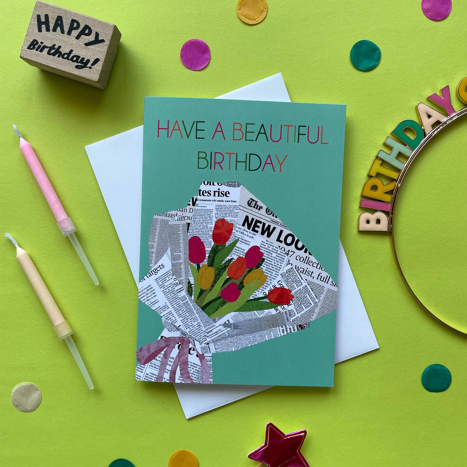 Image of a pastel green card that reads Have a Beautiful Birthday and features a unique, collaged illustration of a bouquet of tulips in newspaper.