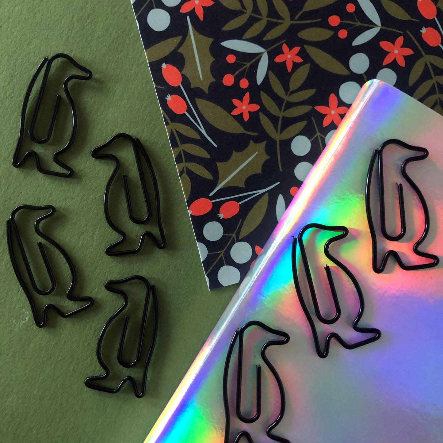 Image shows a set of black penguin shaped paperclips.