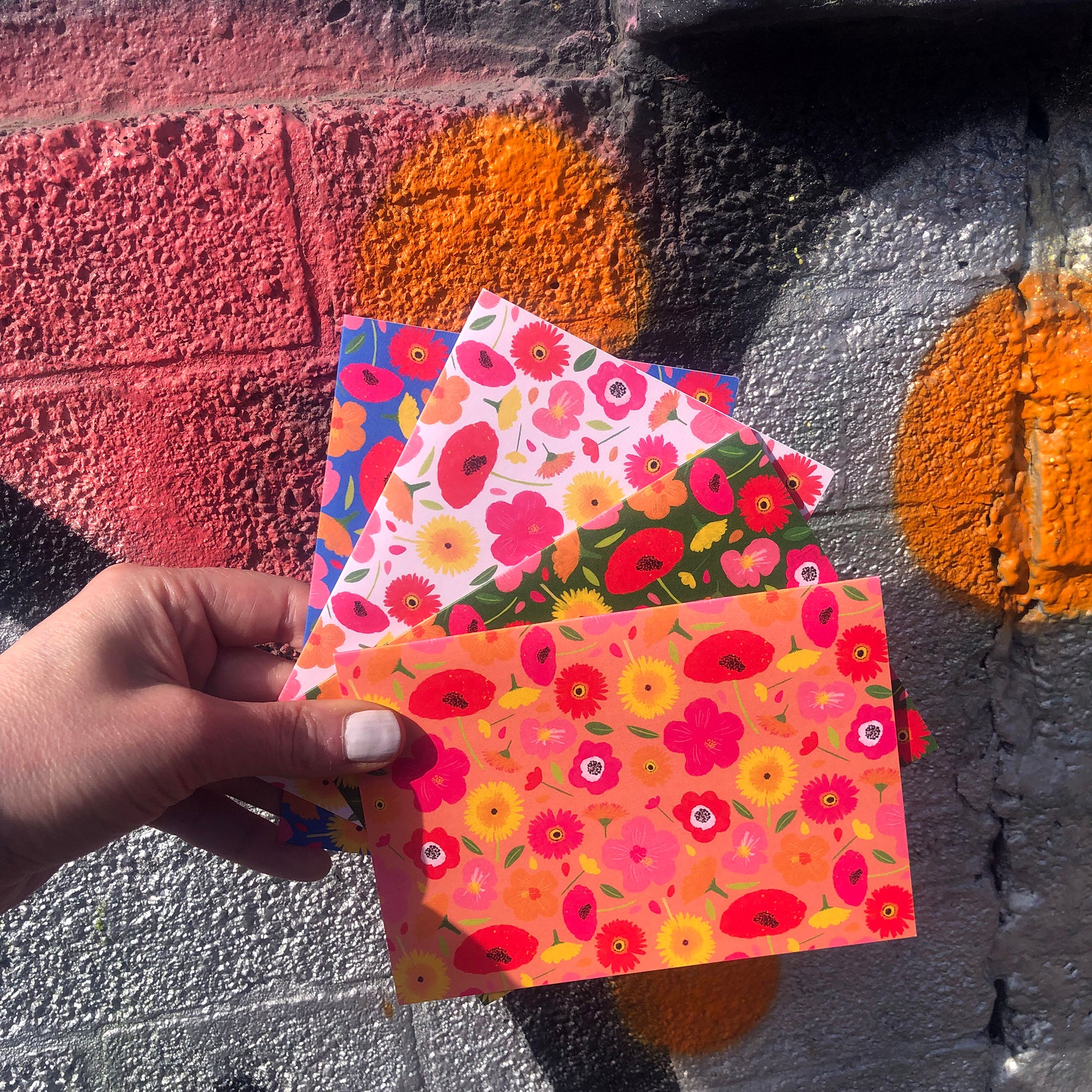 Image shows a set of 4 brightly coloured floral print notecards