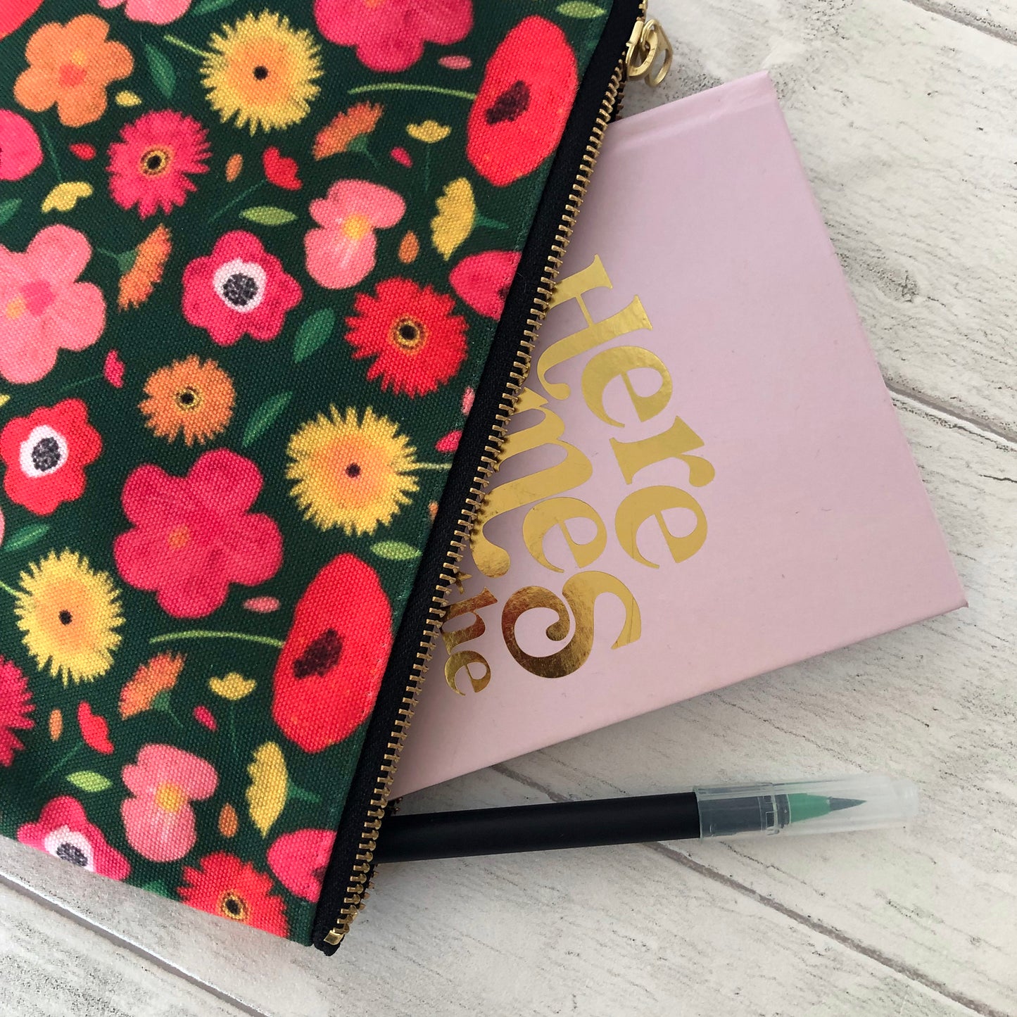 Useful zip pouch in a lush green colour with a pretty pink, yellow and orange floral print