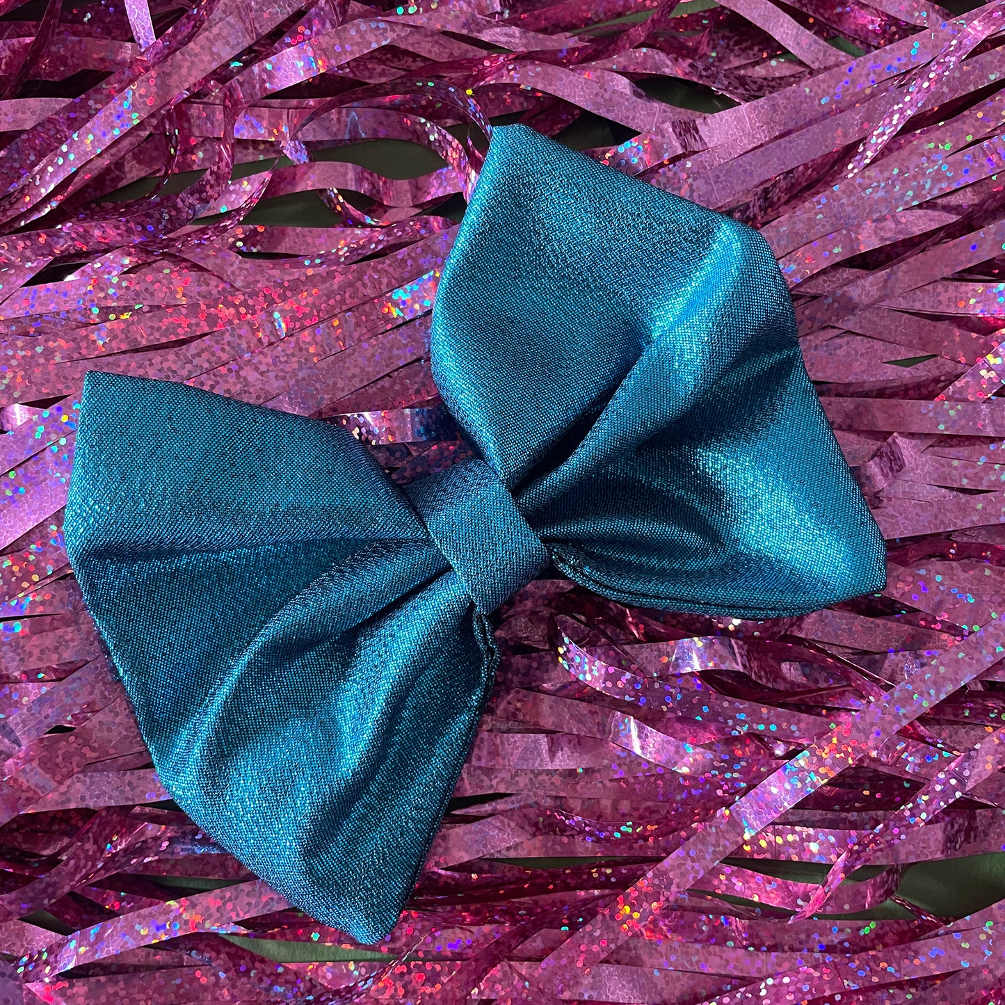 Image shows a blue metallic hair bow made from high quality lamé fabric.