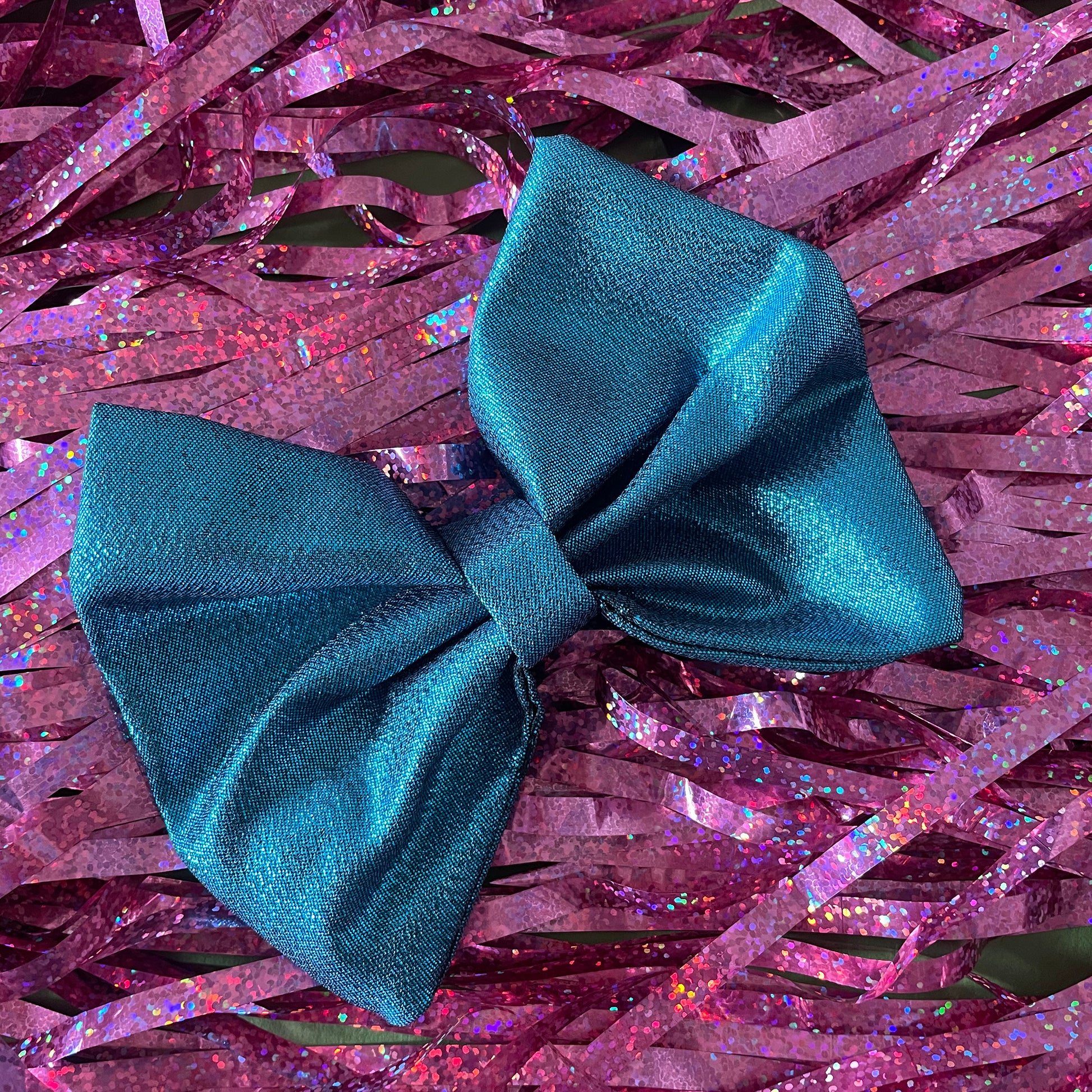 Image shows a blue metallic hair bow made from high quality lamé fabric.