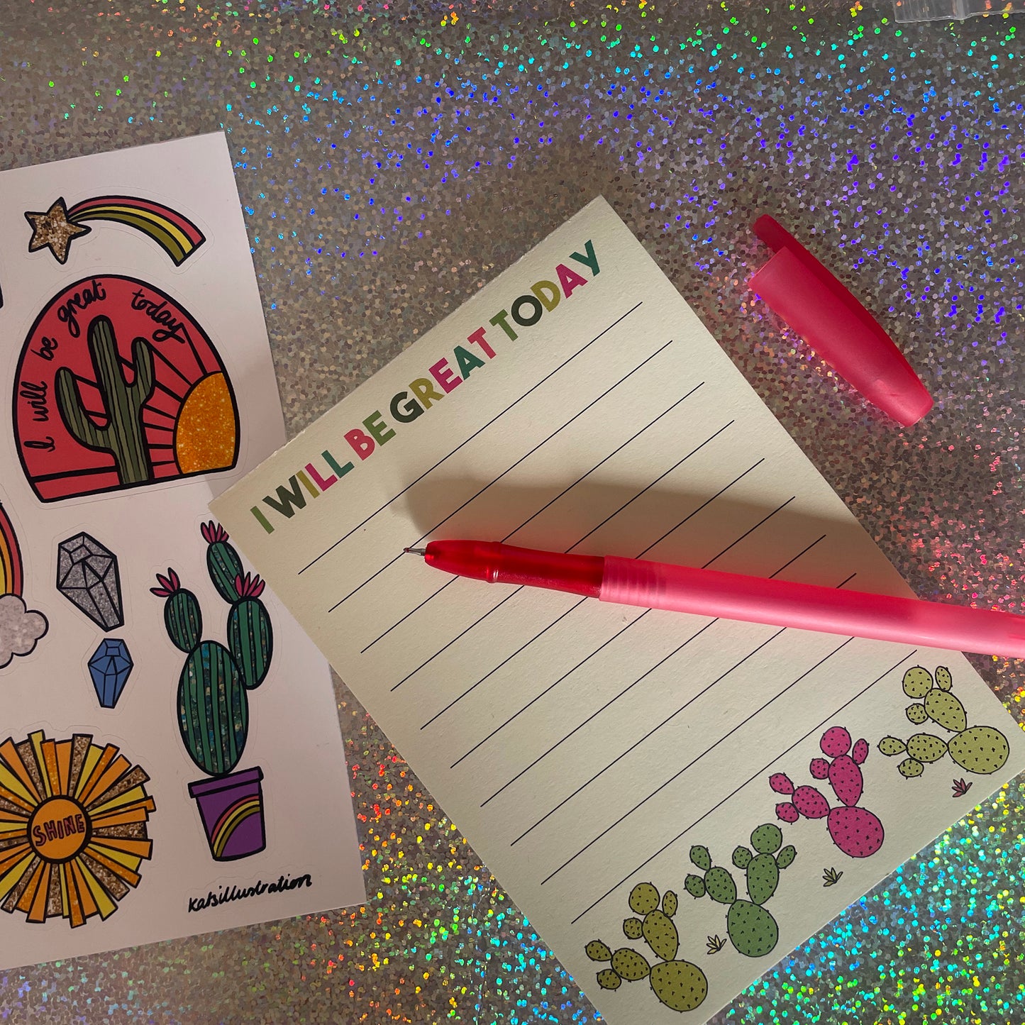 Image shows a lined a6 notepad with neon cactus illustrations and the words 'I will be great today'