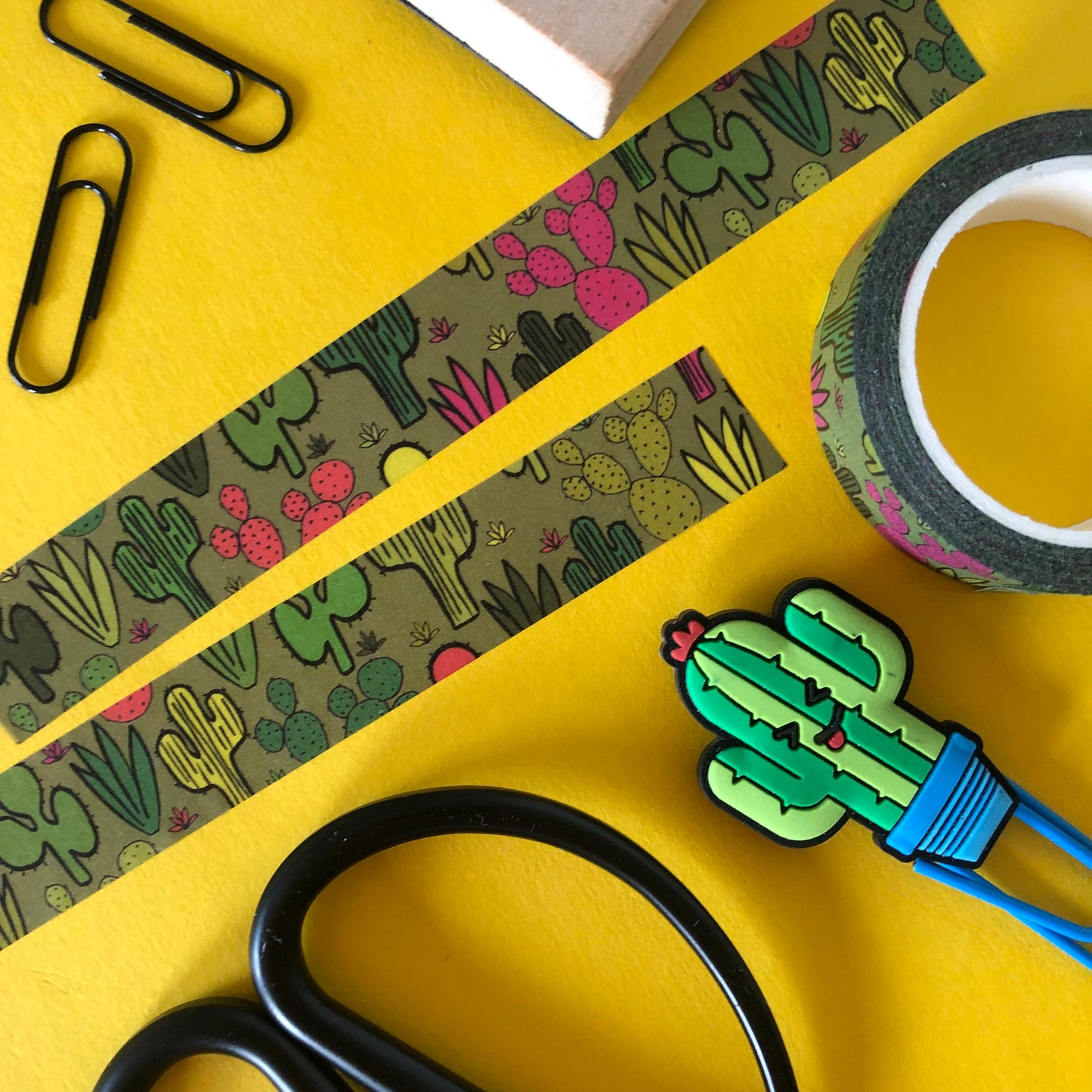 Image shows a green washi tape with a colourful cactus plant print