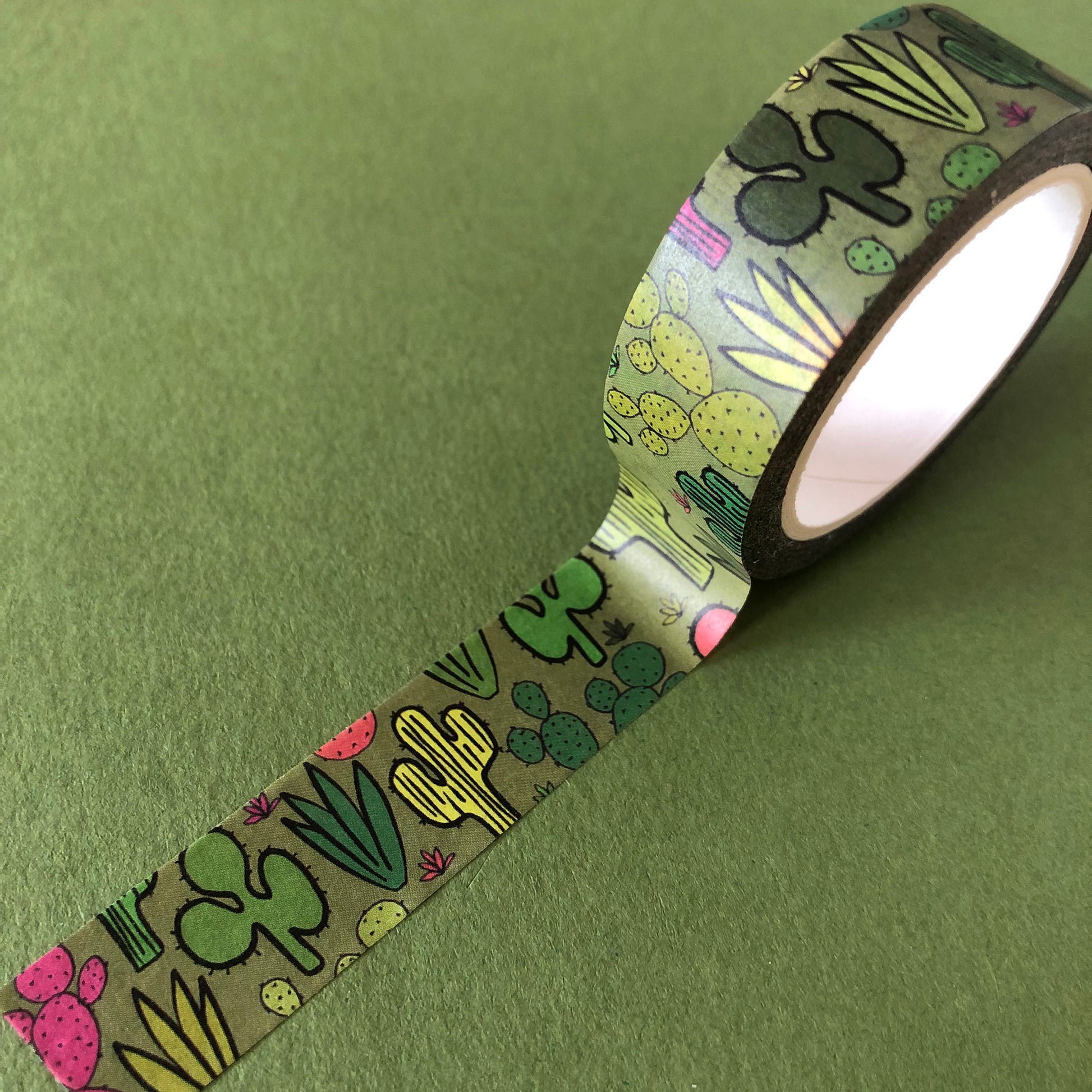 Image shows a green washi tape with a colourful cactus plant print