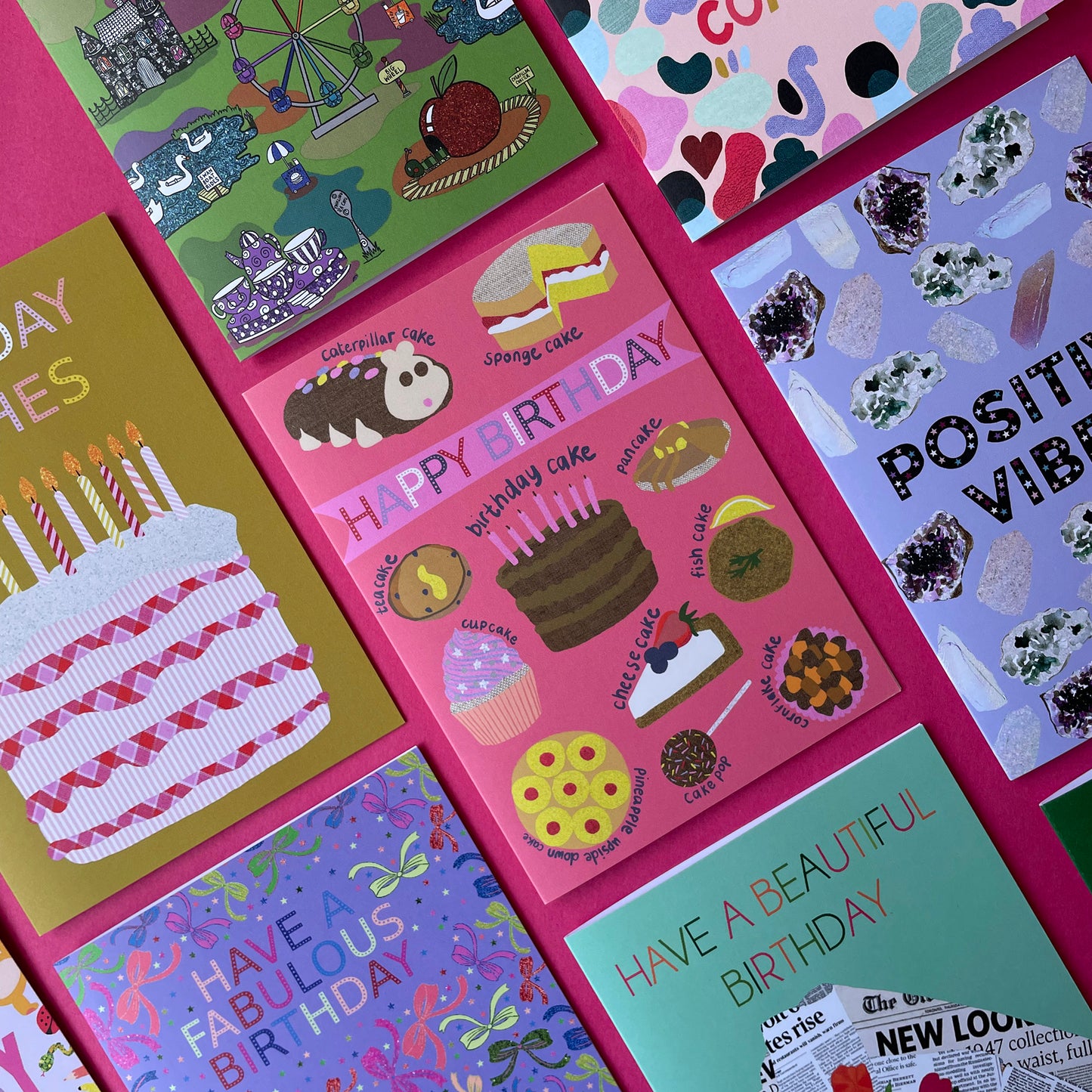 Image shows a pink birthday card with illustrations of different sorts of cakes and the words Happy Birthday