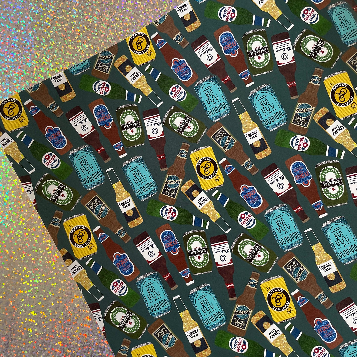 Image shows a green blue gift wrap with illustrations of different beers patterned design