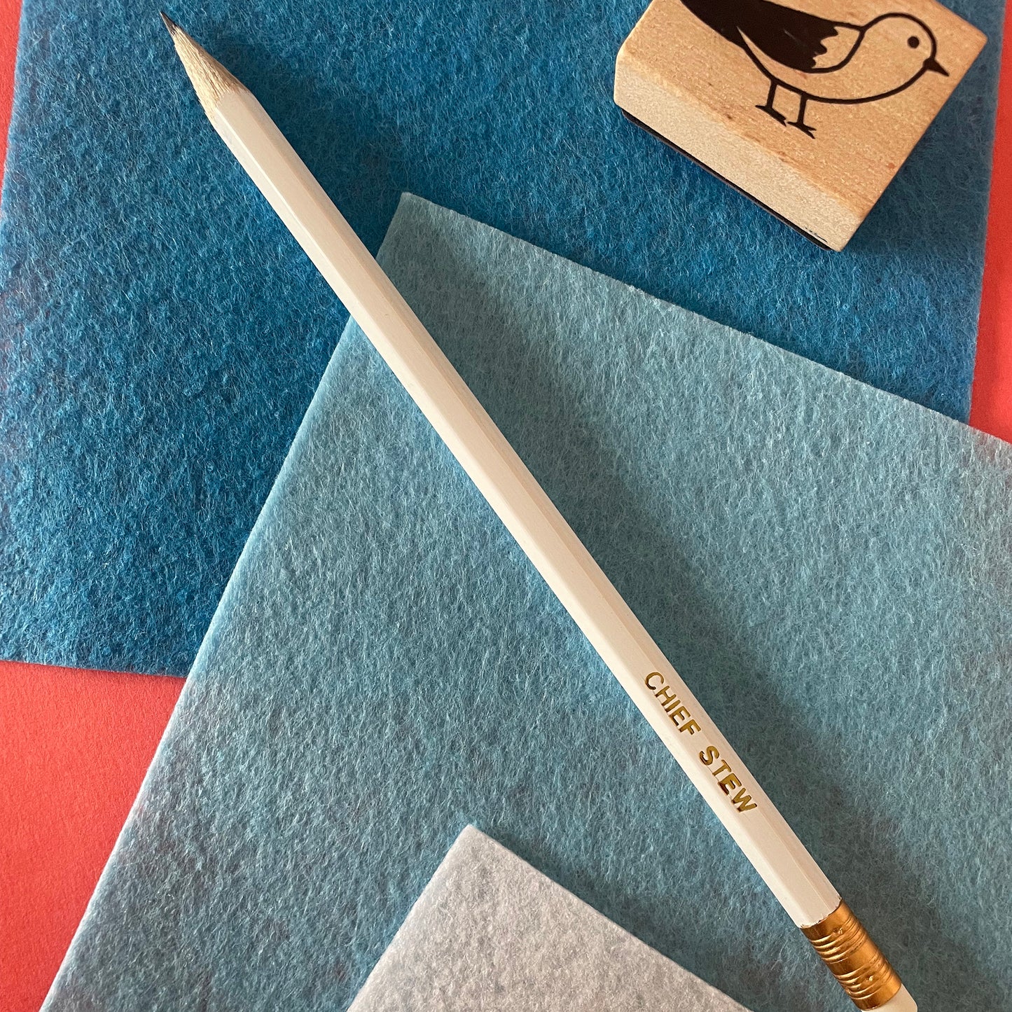 Image of a white pencil with 'chief stew' embossed on it in gold lettering
