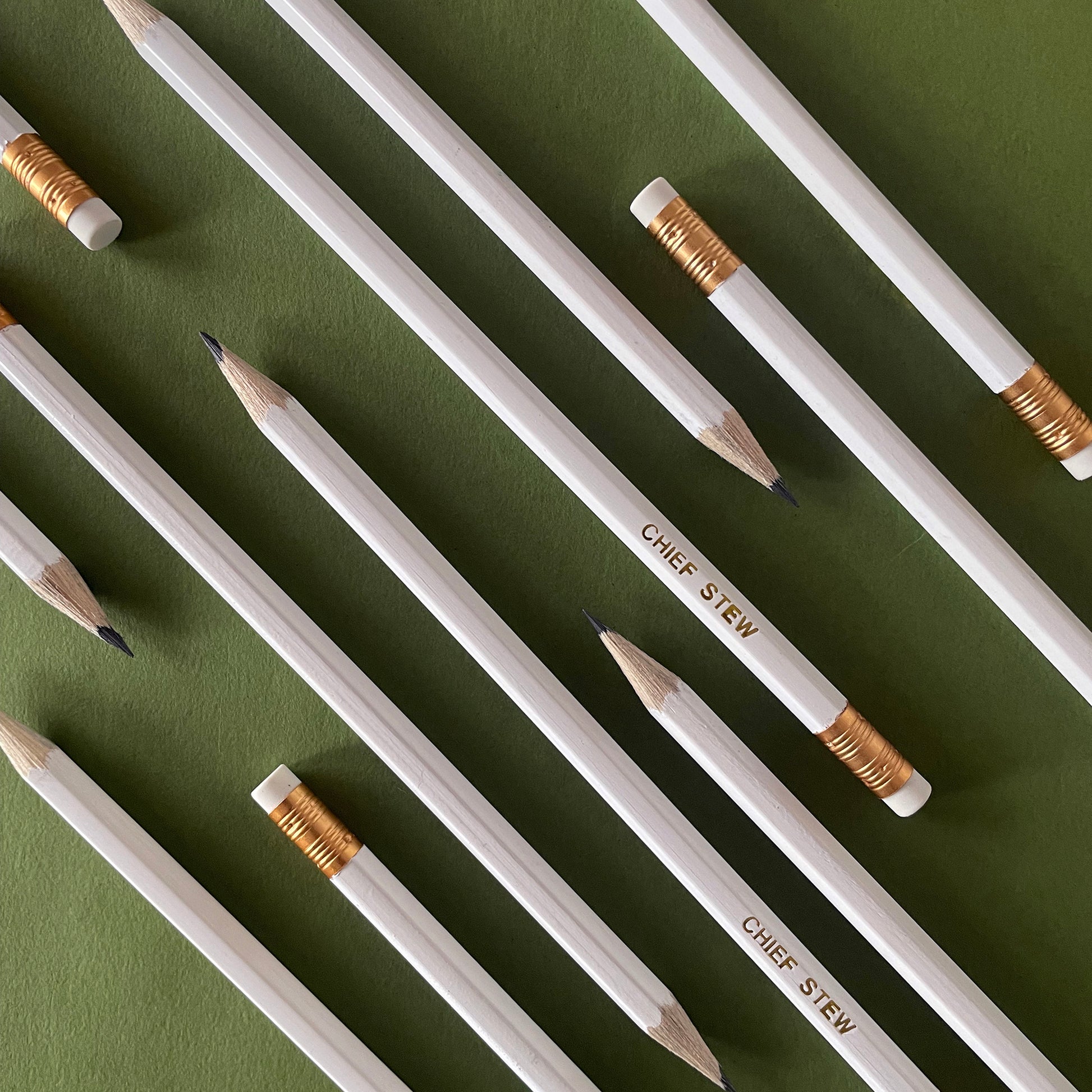 Image of a white pencil with 'chief stew' embossed on it in gold lettering