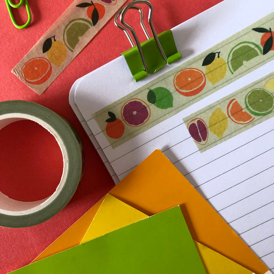 Image shows a pale green washi tape with a colourful citrus fruit print