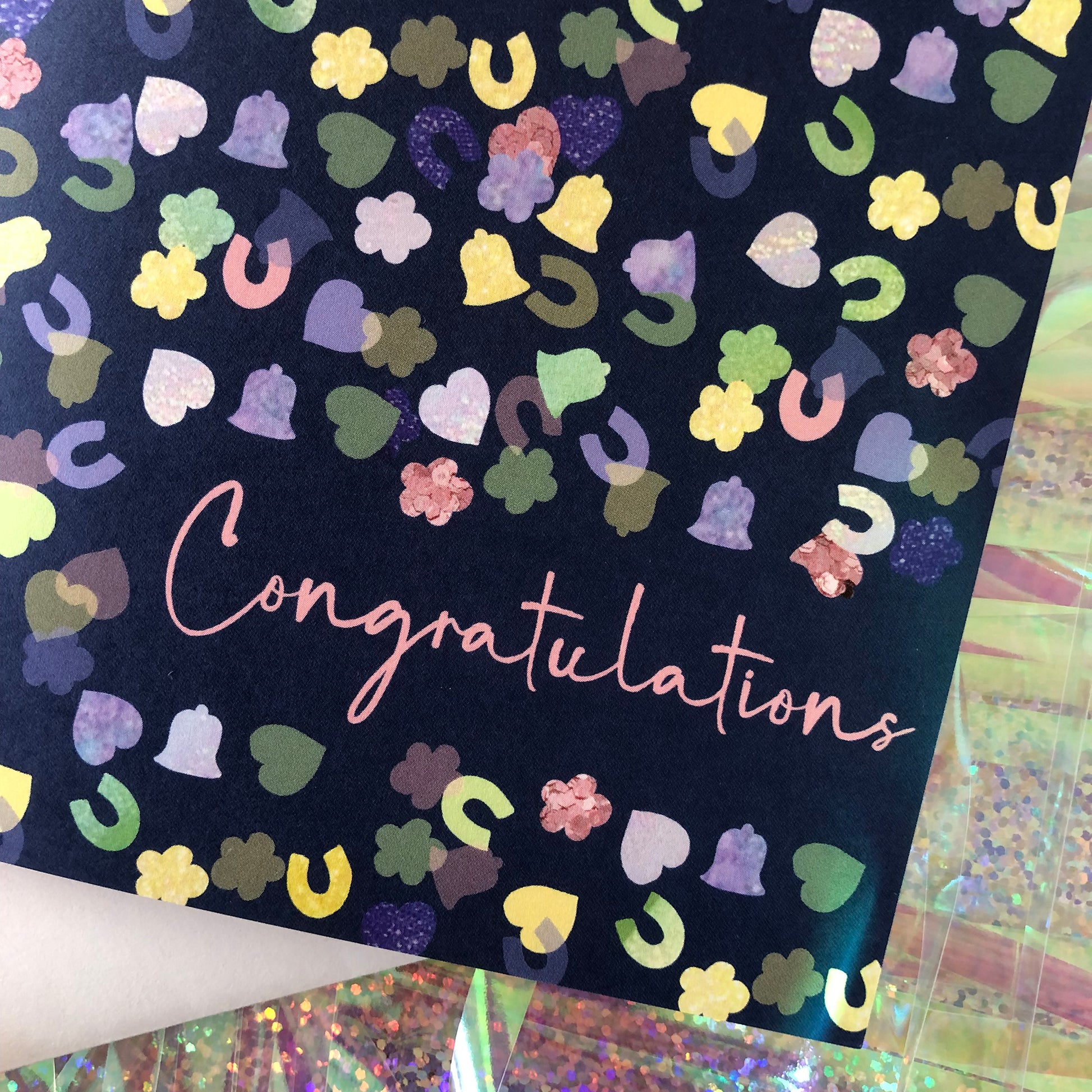 Image shows a navy blue card with a confetti print pattern and 'Congratulations' in pink writing