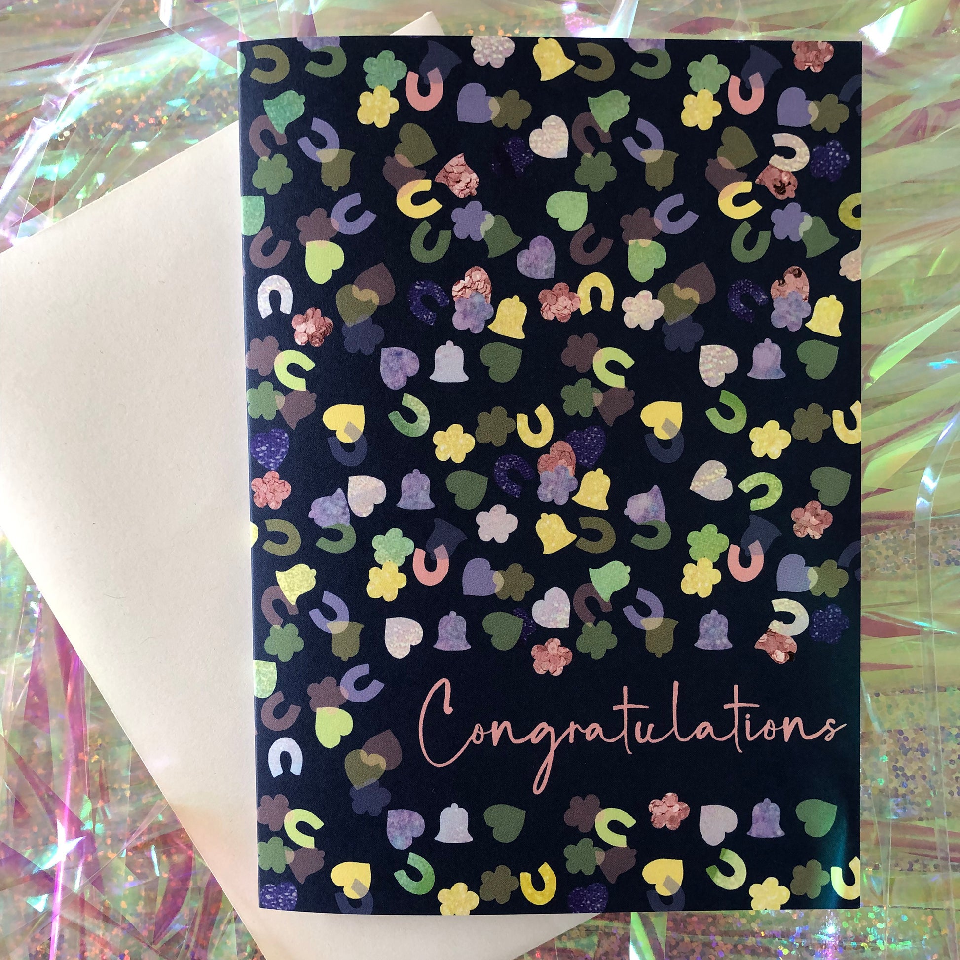 Image shows a navy blue card with a confetti print pattern and 'Congratulations' in pink writing