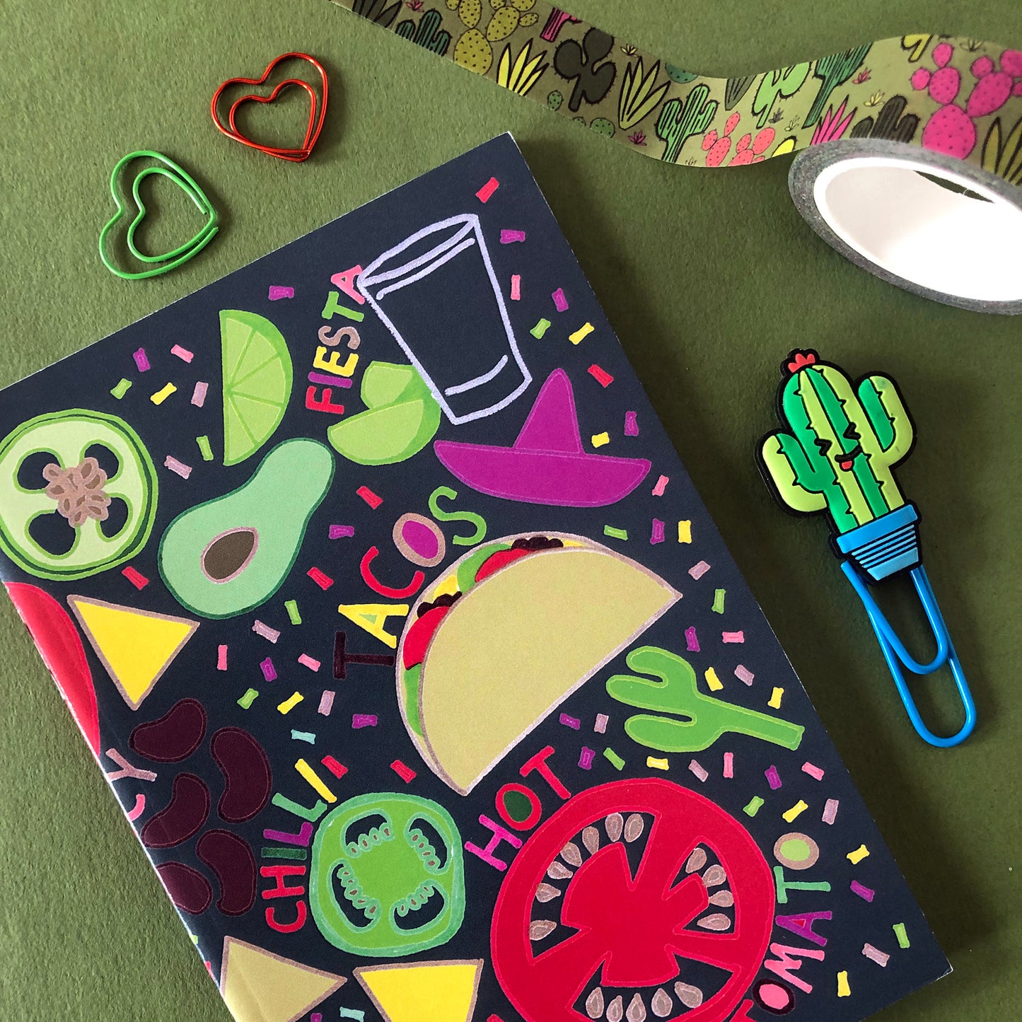 Image shows a bright and colourful notebook with illustrations of mexican food ingredients, words and confetti in a hand drawn style