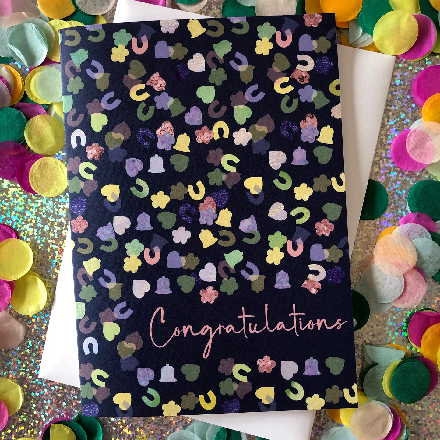 Image shows a navy blue card with a confetti print pattern and 'Congratulations' in pink writing