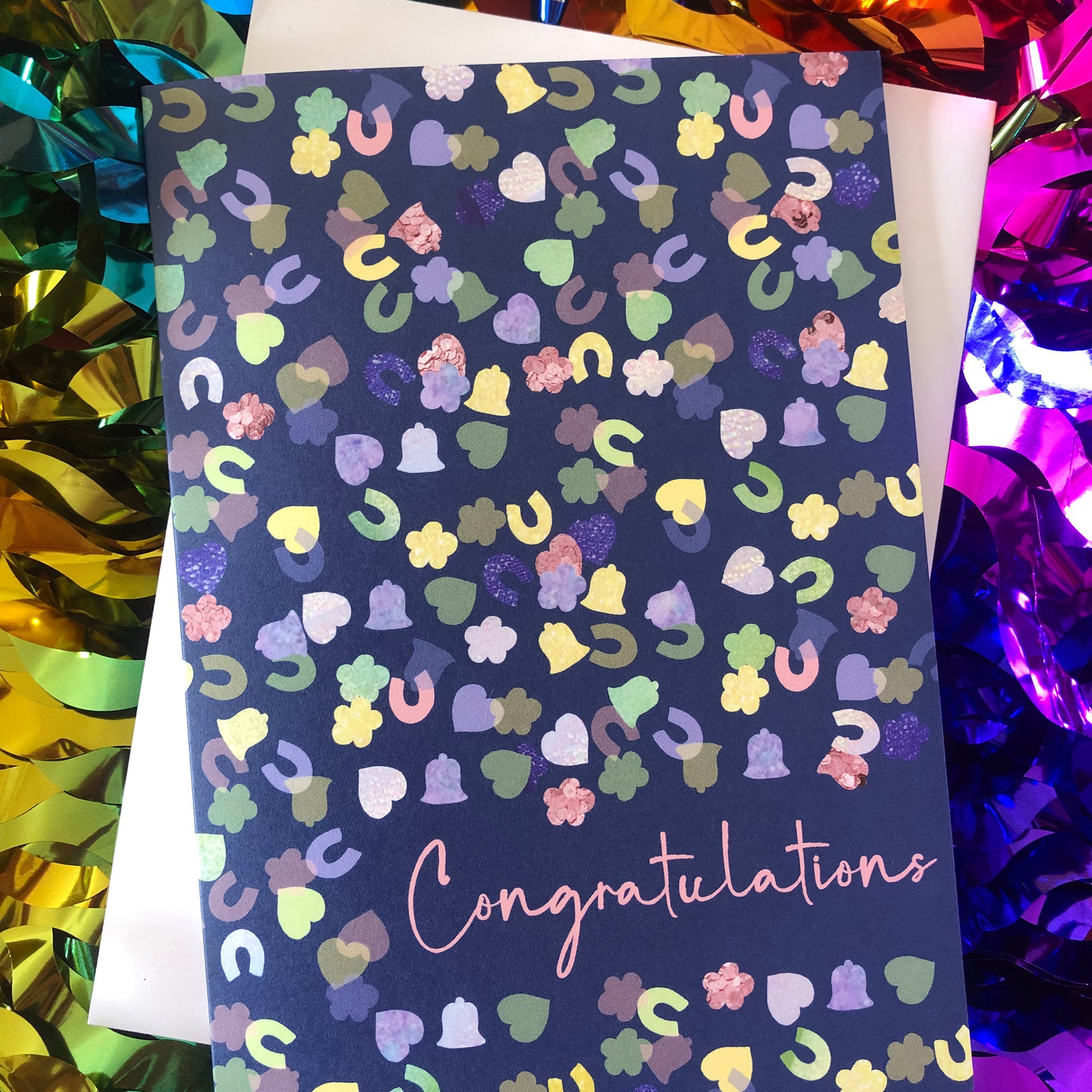 Image shows a navy blue card with a confetti print pattern and 'Congratulations' in pink writing
