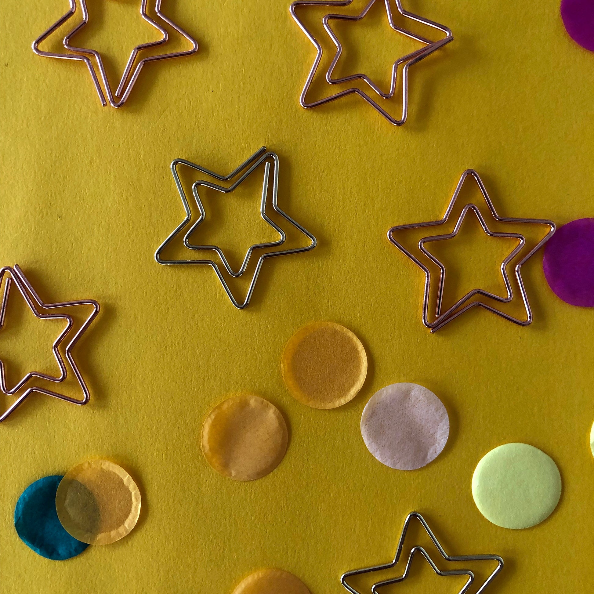 Image shows a set of gold and rose gold, star shaped paperclips.