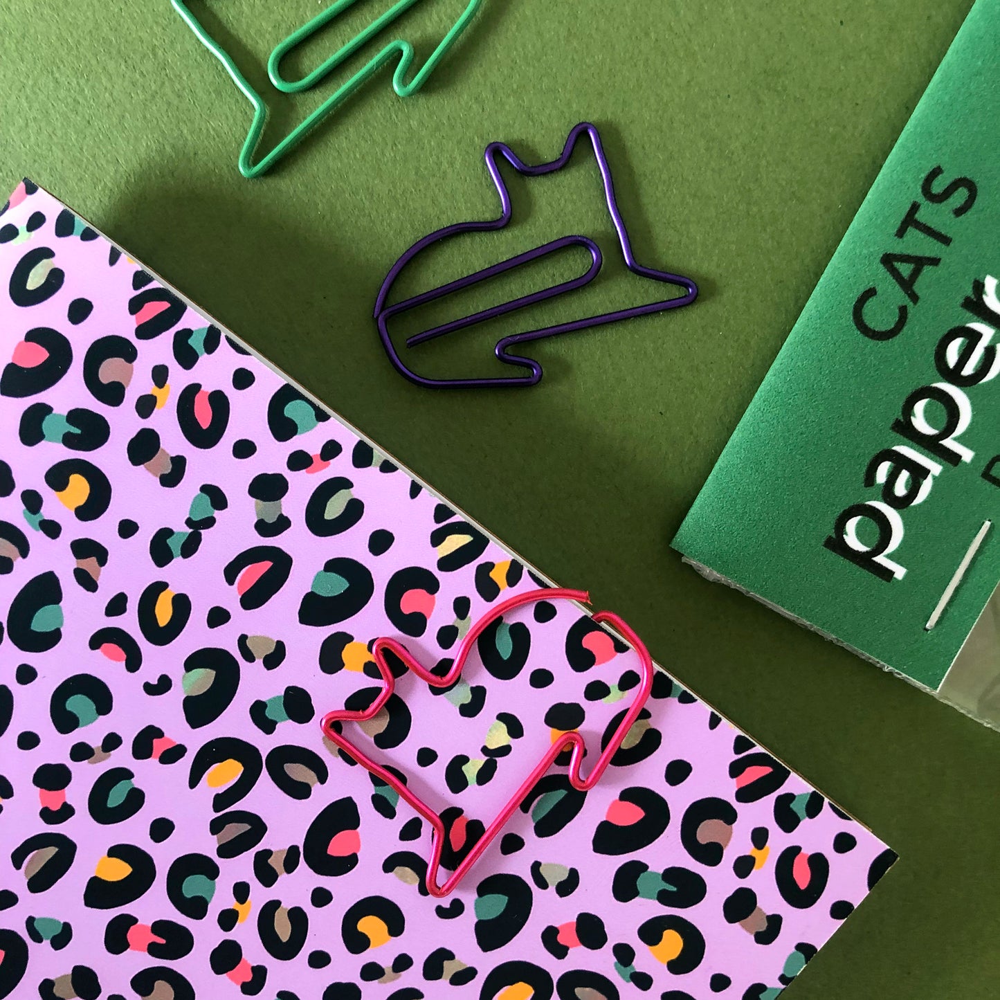 Image shows a set of cute and colourful, cat shaped paperclips.