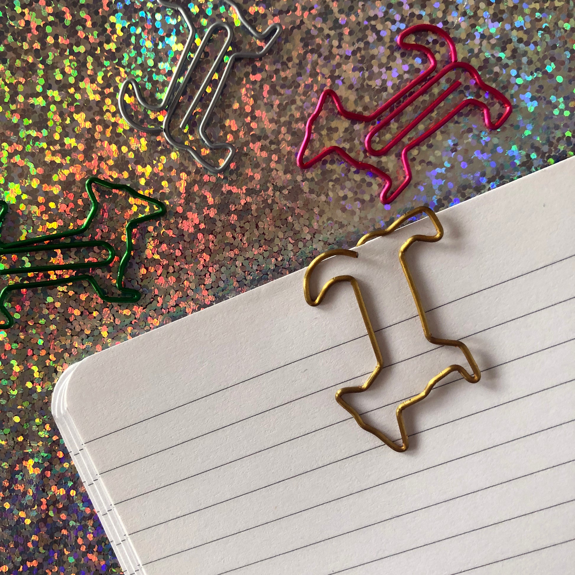 Image shows a set of cute and colourful, dog shaped paperclips.