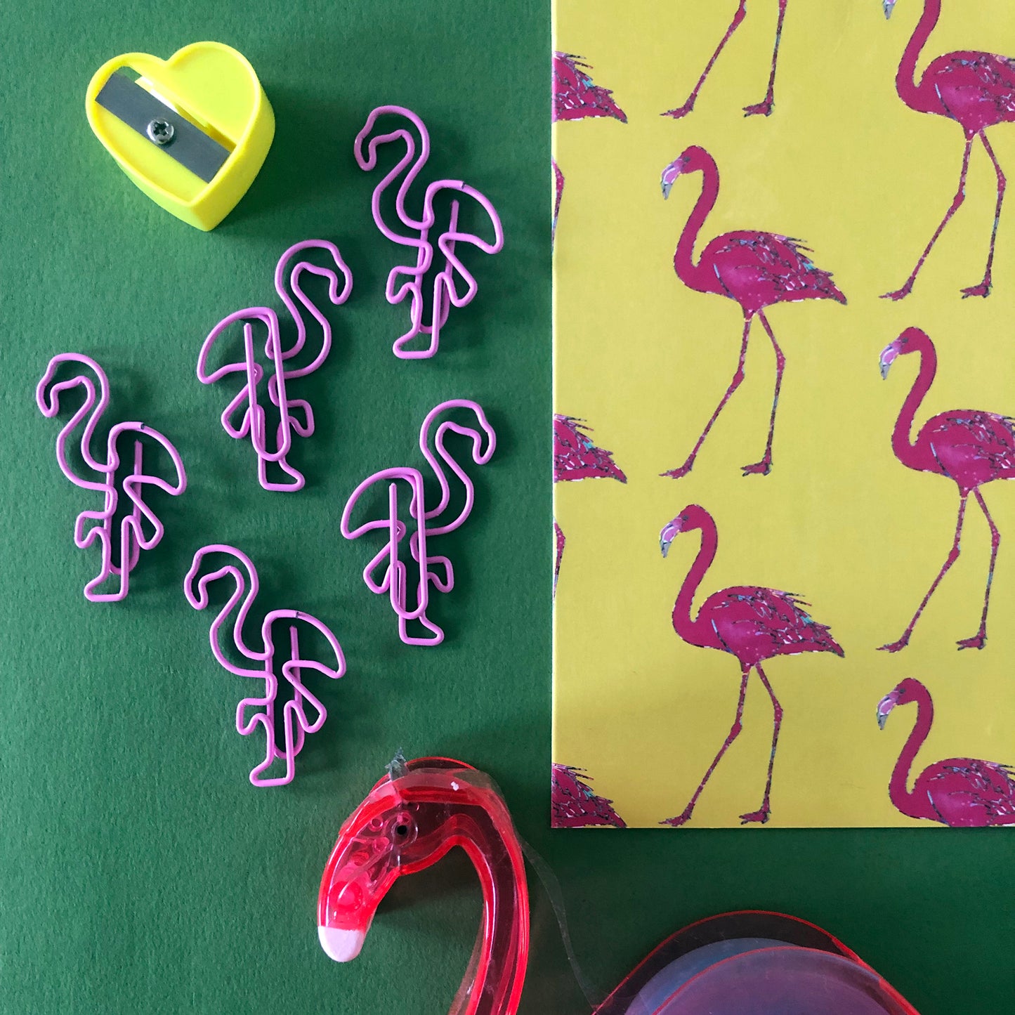 Image shows a set of pink flamingo shaped paperclips.