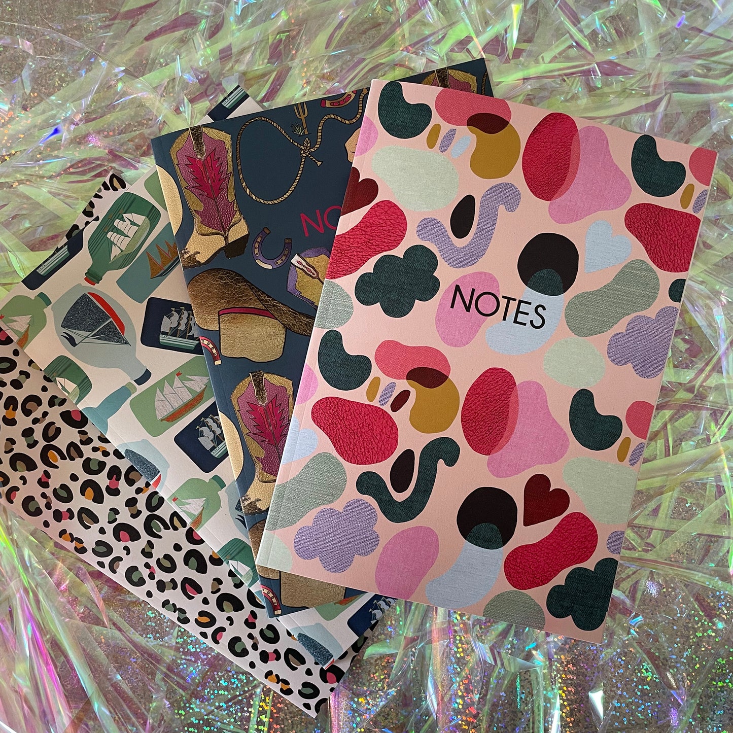 Image of a colourful notebook with a textured shapes pattern in bright colours and the word notes in black.
