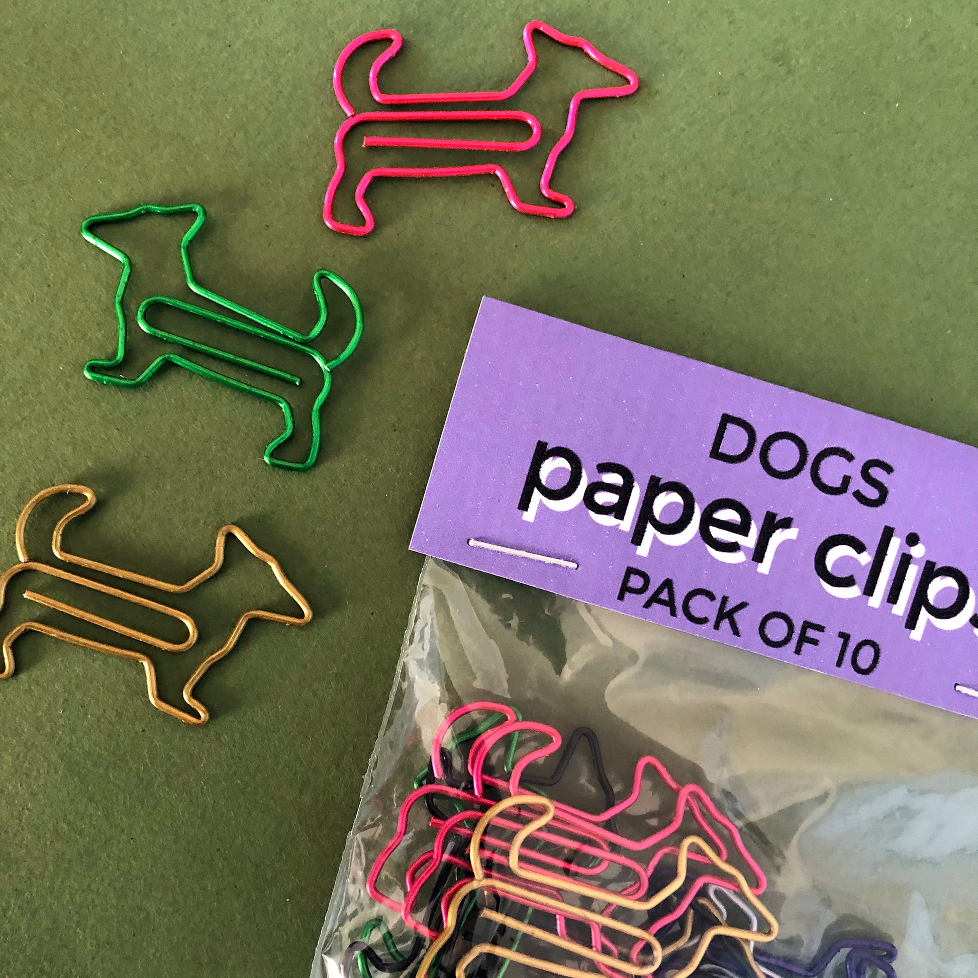 Image shows a set of cute and colourful, dog shaped paperclips.
