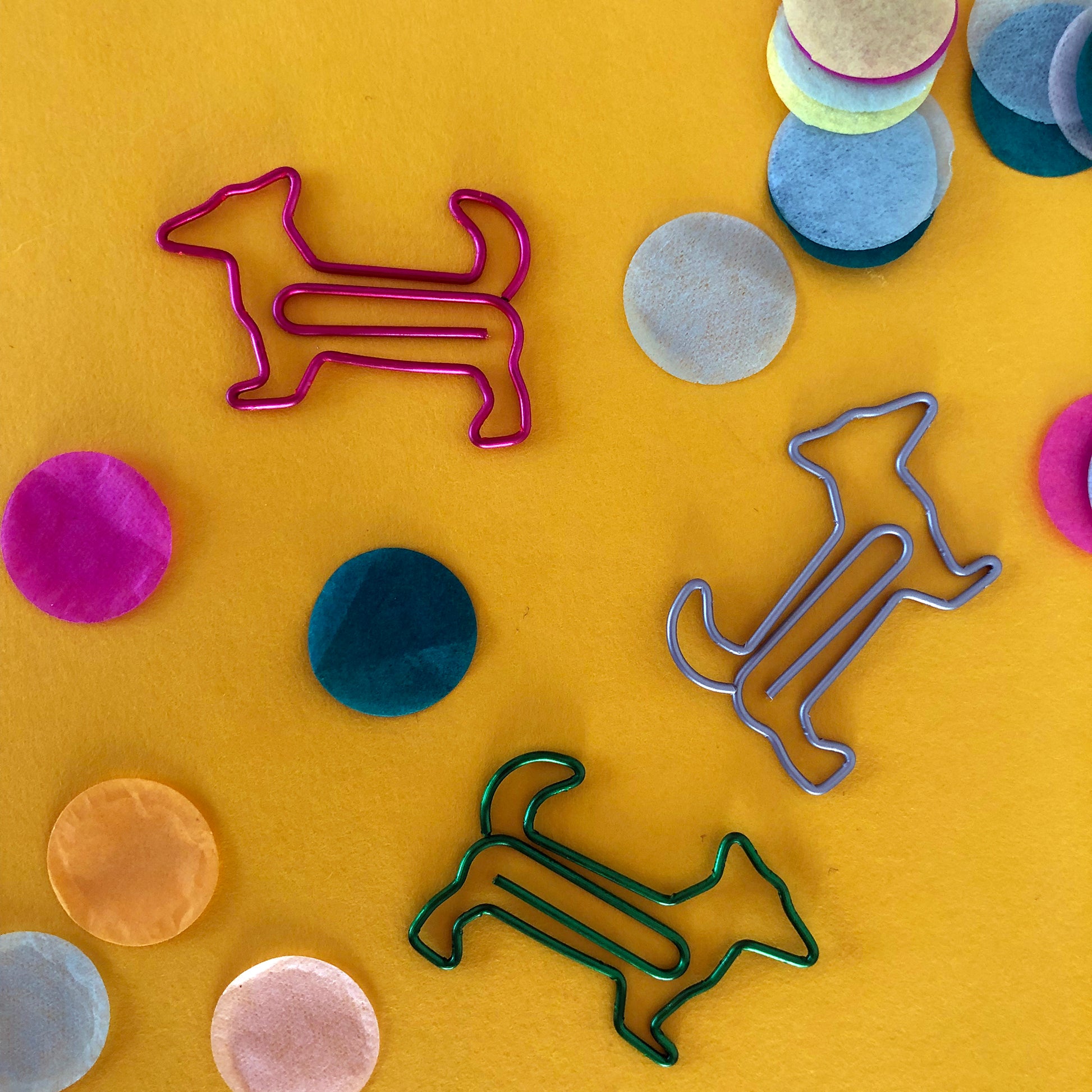 Image shows a set of cute and colourful, dog shaped paperclips.