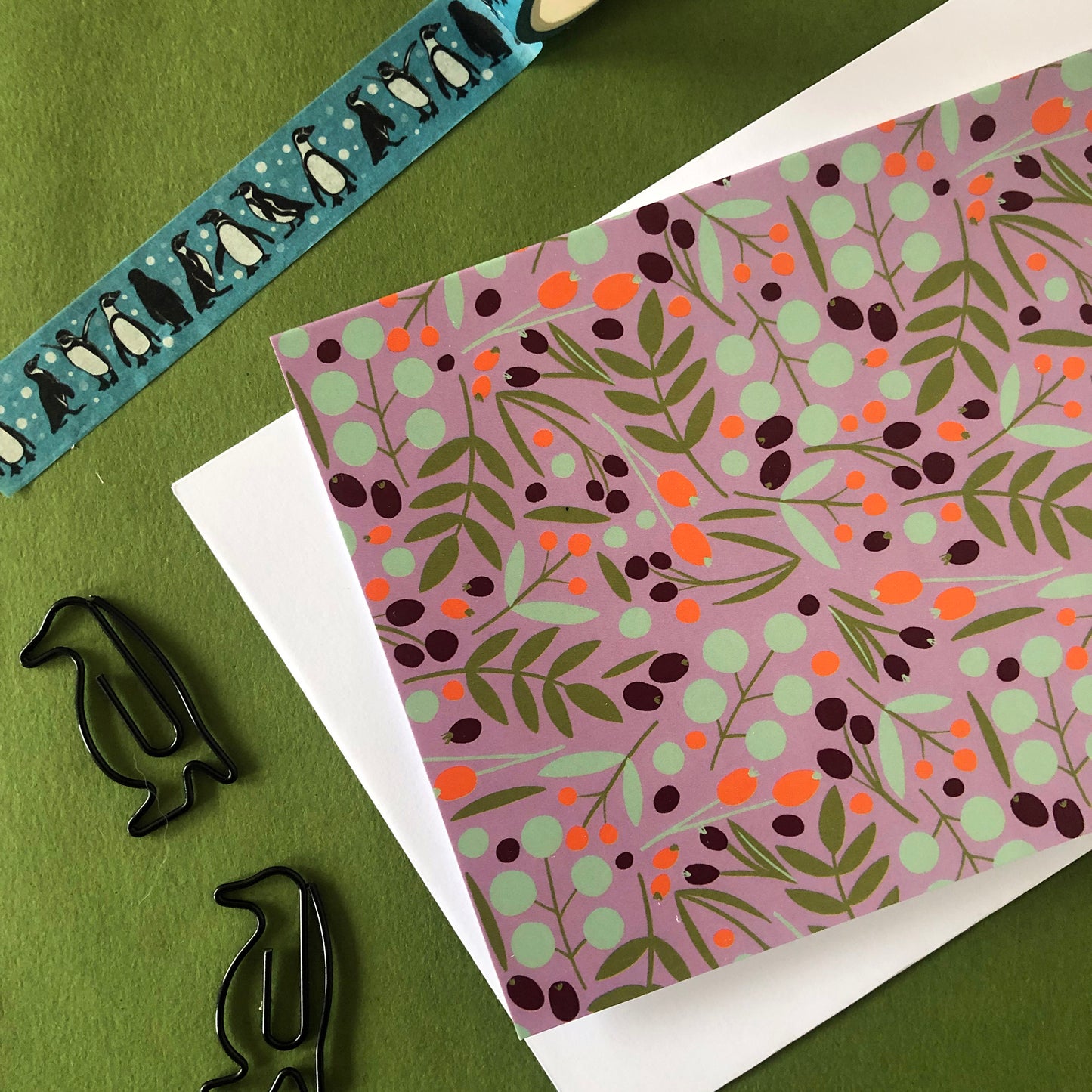 Image shows a festive nature christmas card featuring a leaves and berries pattern.