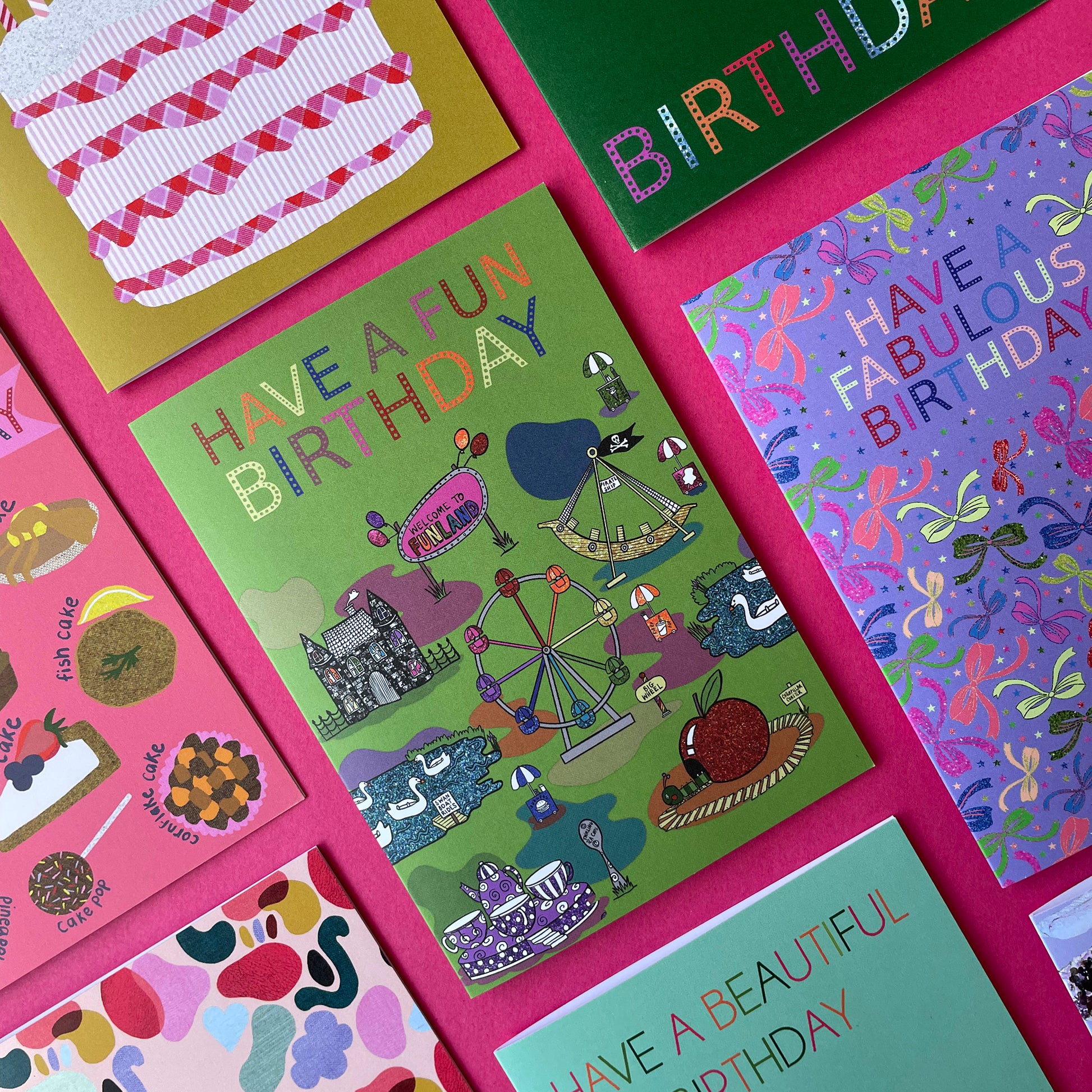 Image shows a green birthday card with illustrations of  vintage theme park rides and the words Have a Fun Birthday