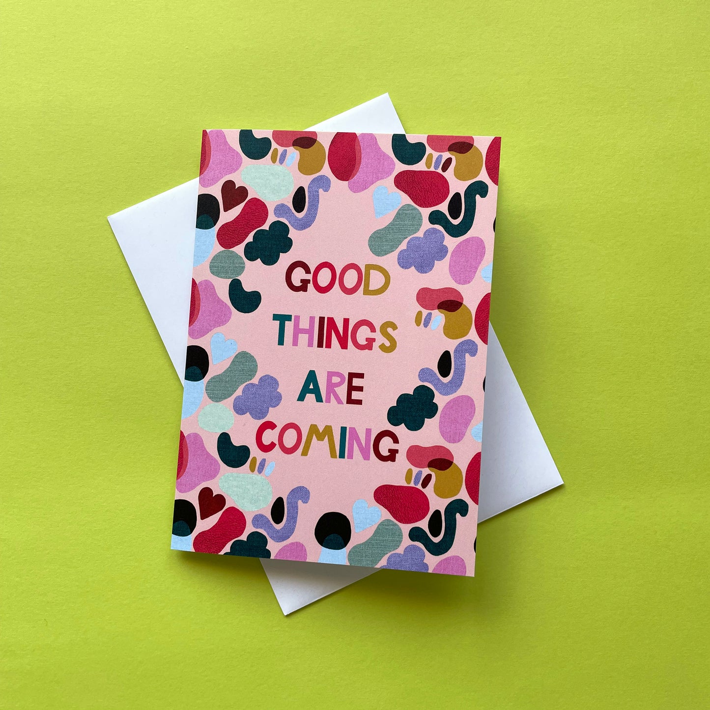 Image of a bright and colourful card with an abstract shape design and the words 'Good Things Are Coming'