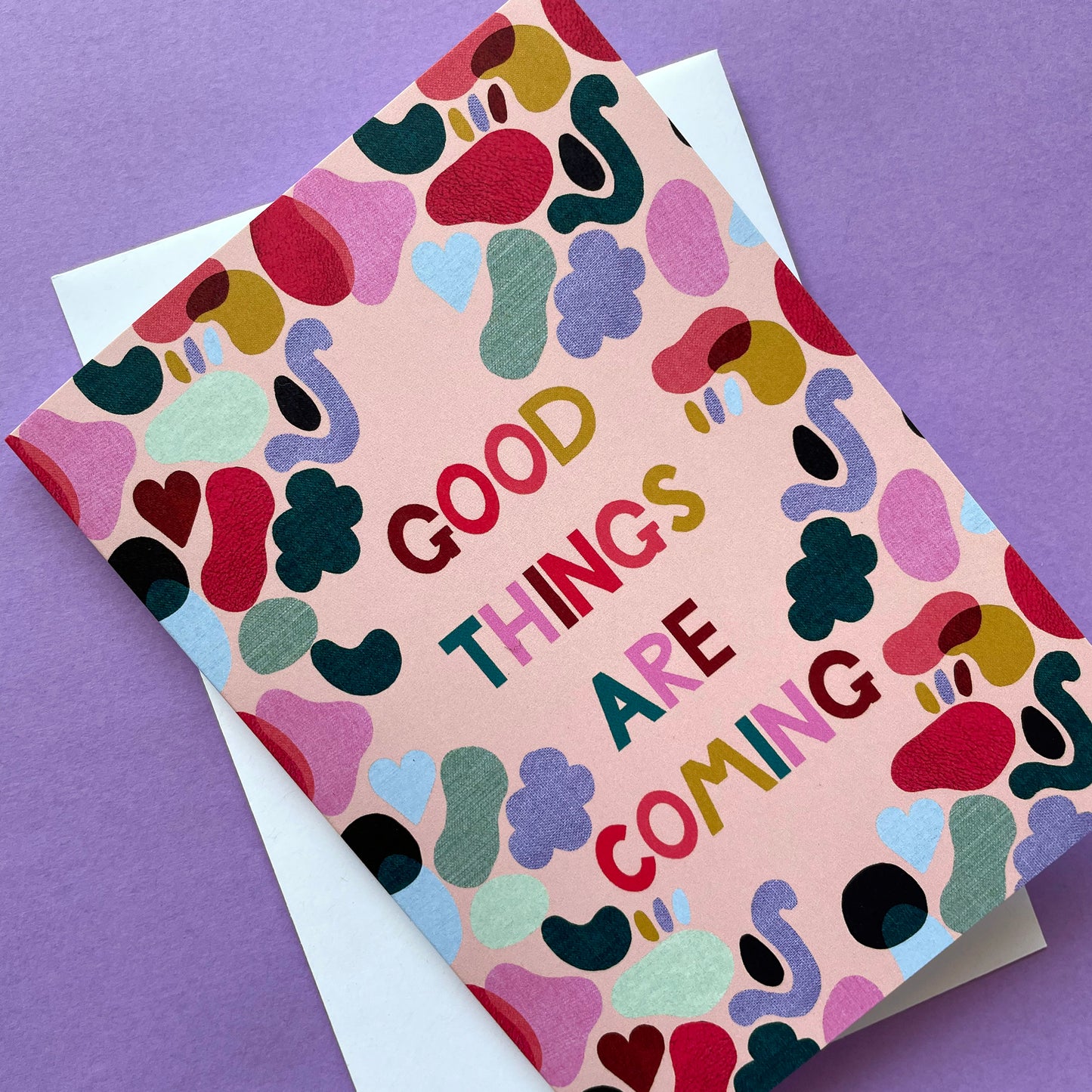 Image of a bright and colourful card with an abstract shape design and the words 'Good Things Are Coming'