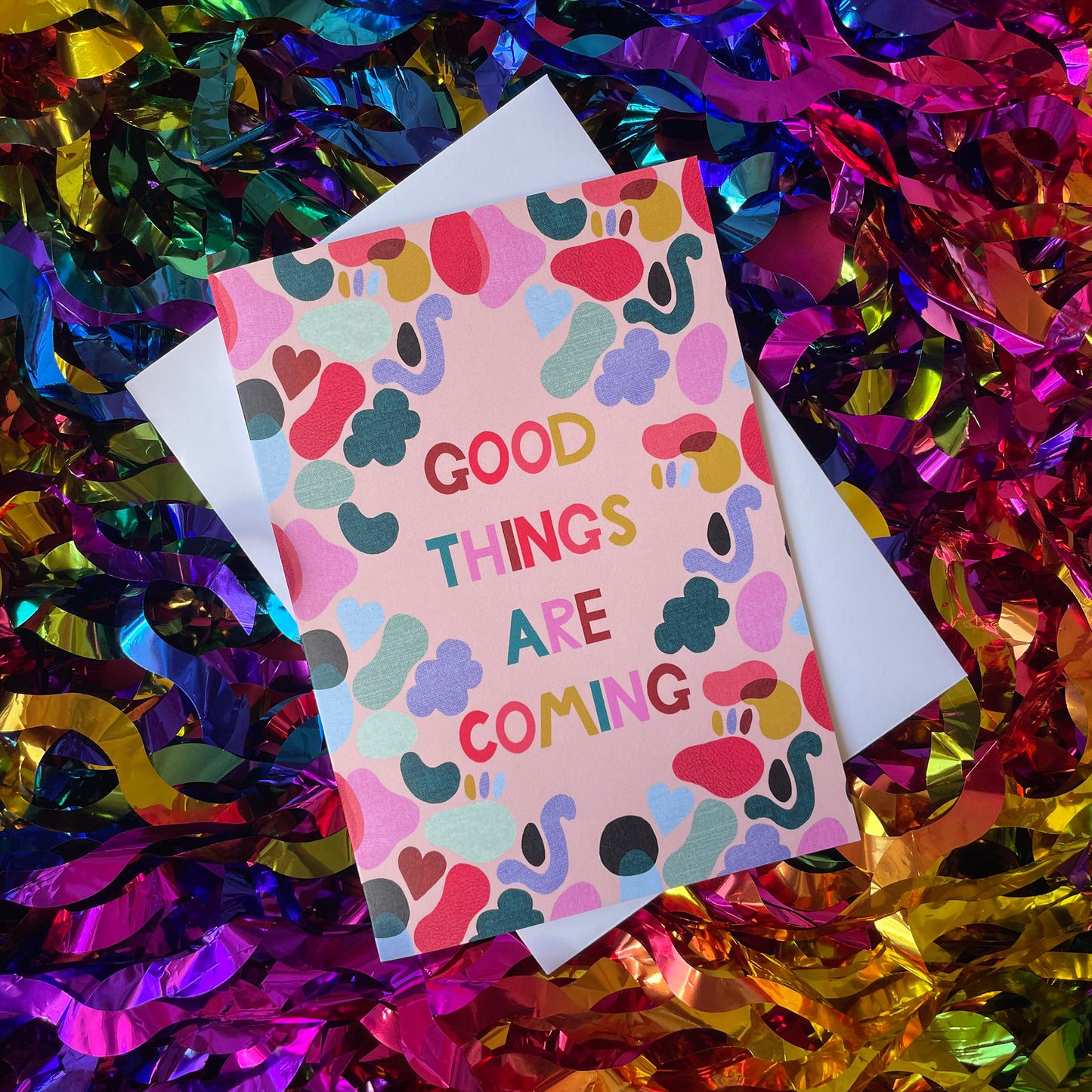 Image of a bright and colourful card with an abstract shape design and the words 'Good Things Are Coming'