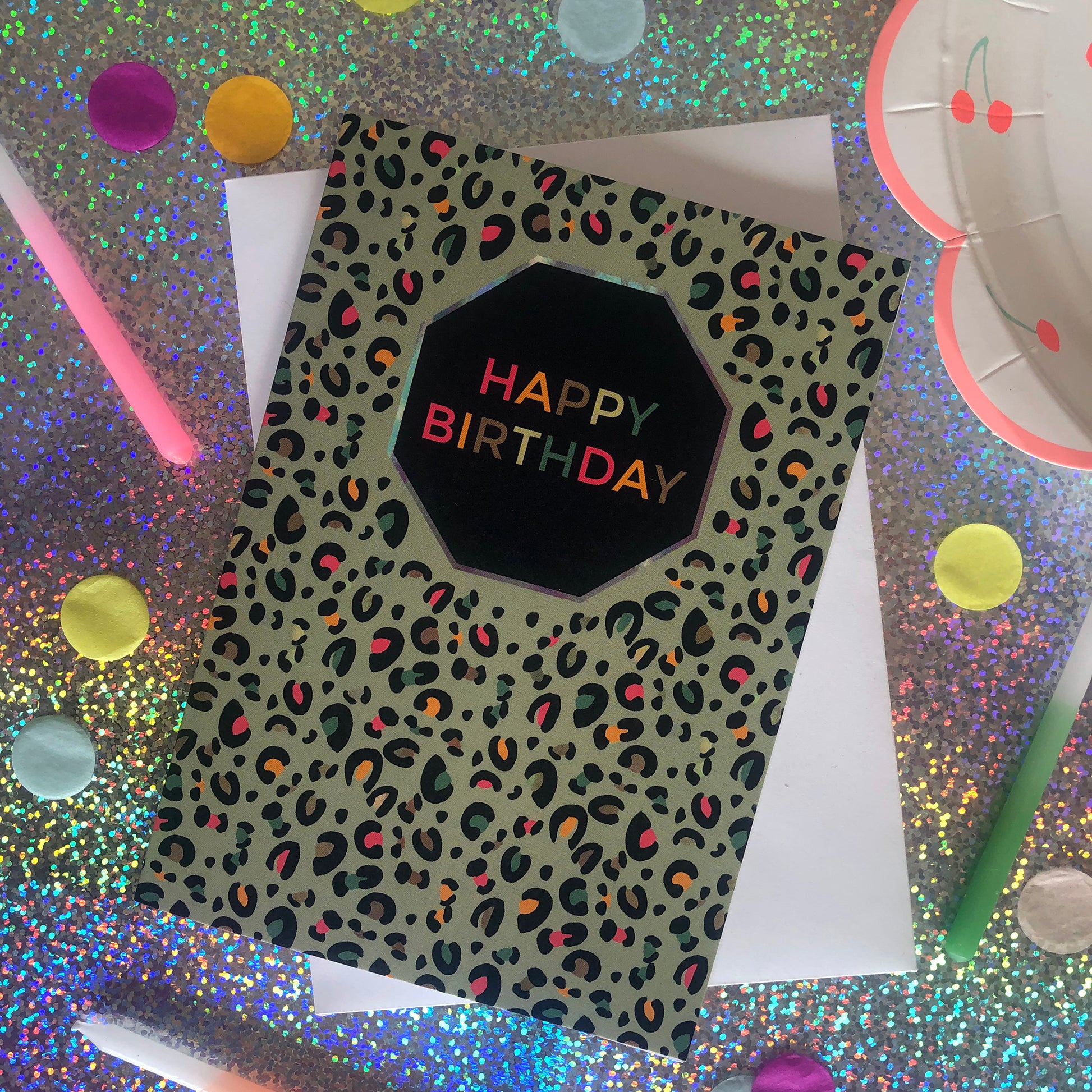 Image shows a fun Happy Birthday card with pale green leopard print and pops of neon.