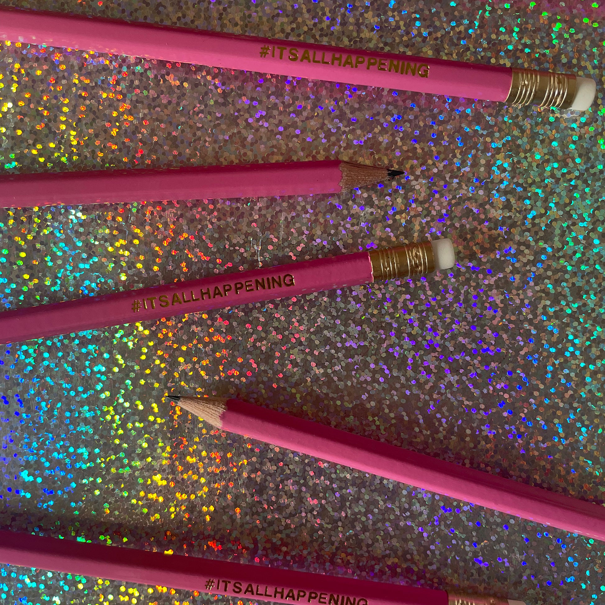 Image shows a pink pencil with gold lettering that says #itsallhappening
