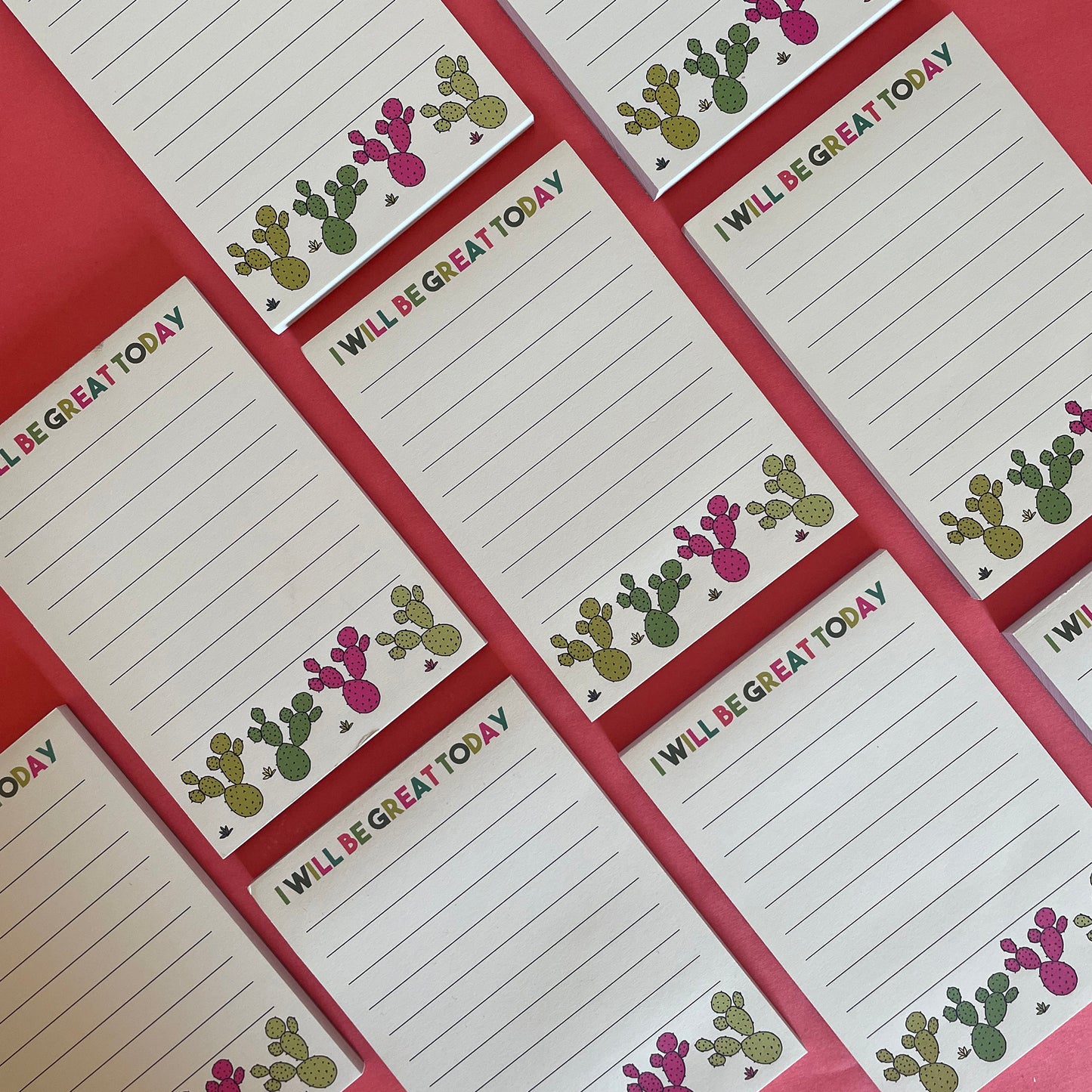 Image shows a lined a6 notepad with neon cactus illustrations and the words 'I will be great today'