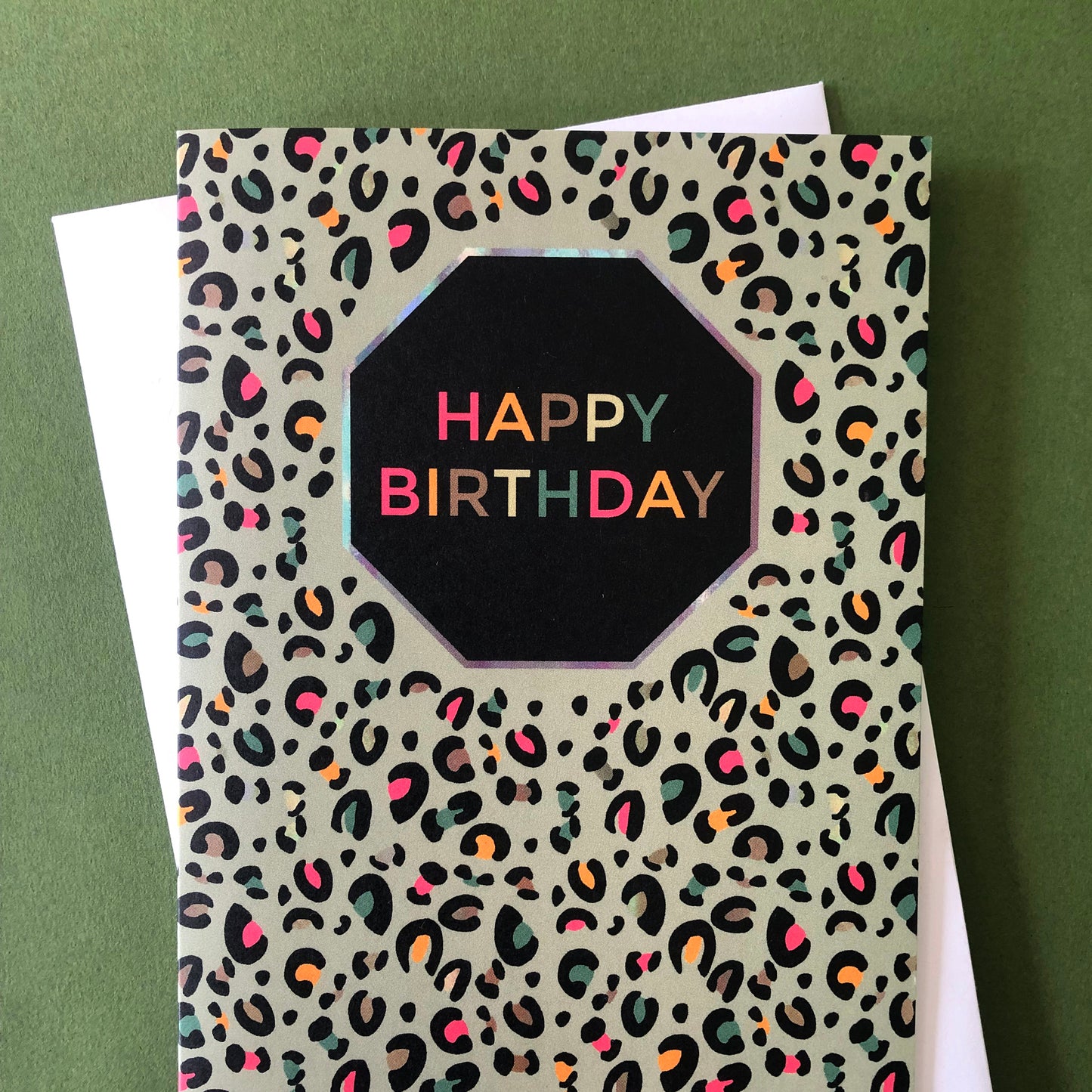 Image shows a fun Happy Birthday card with pale green leopard print and pops of neon.