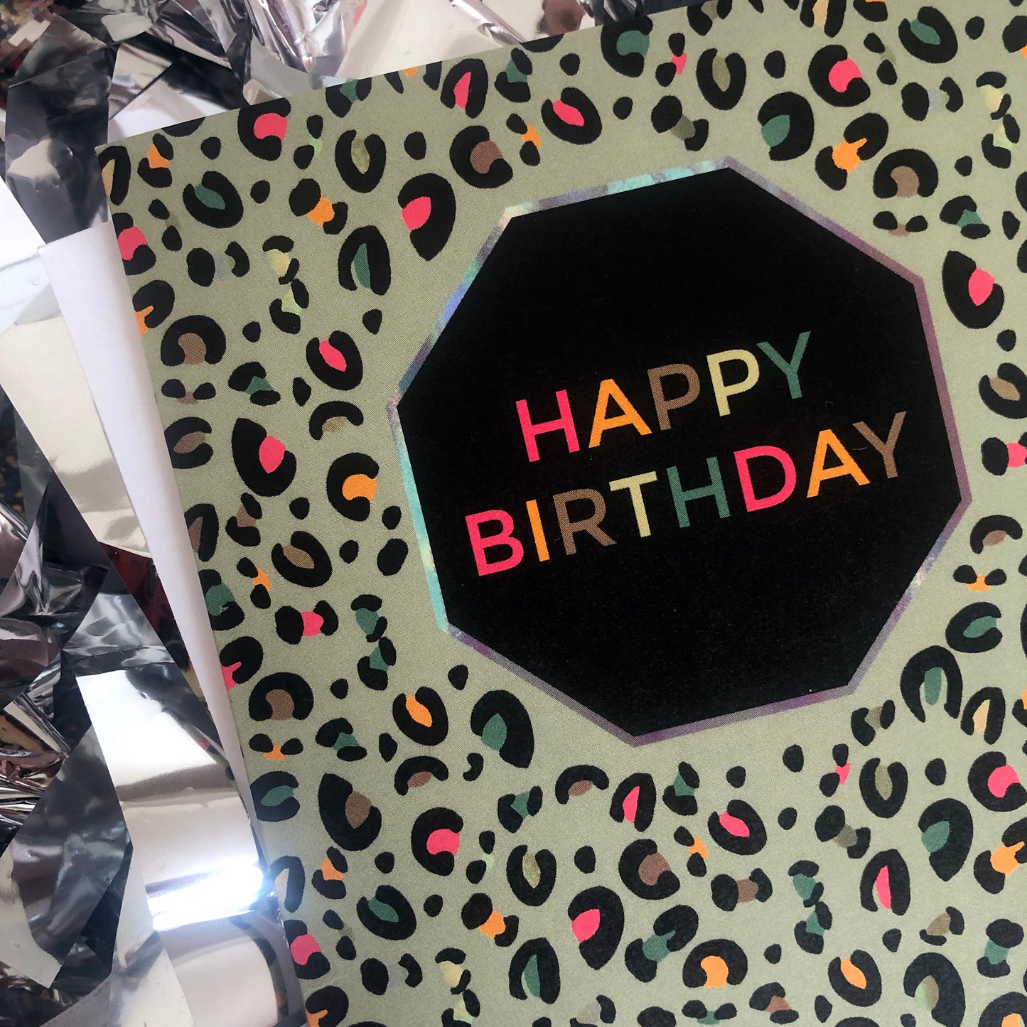 Image shows a fun Happy Birthday card with pale green leopard print and pops of neon.