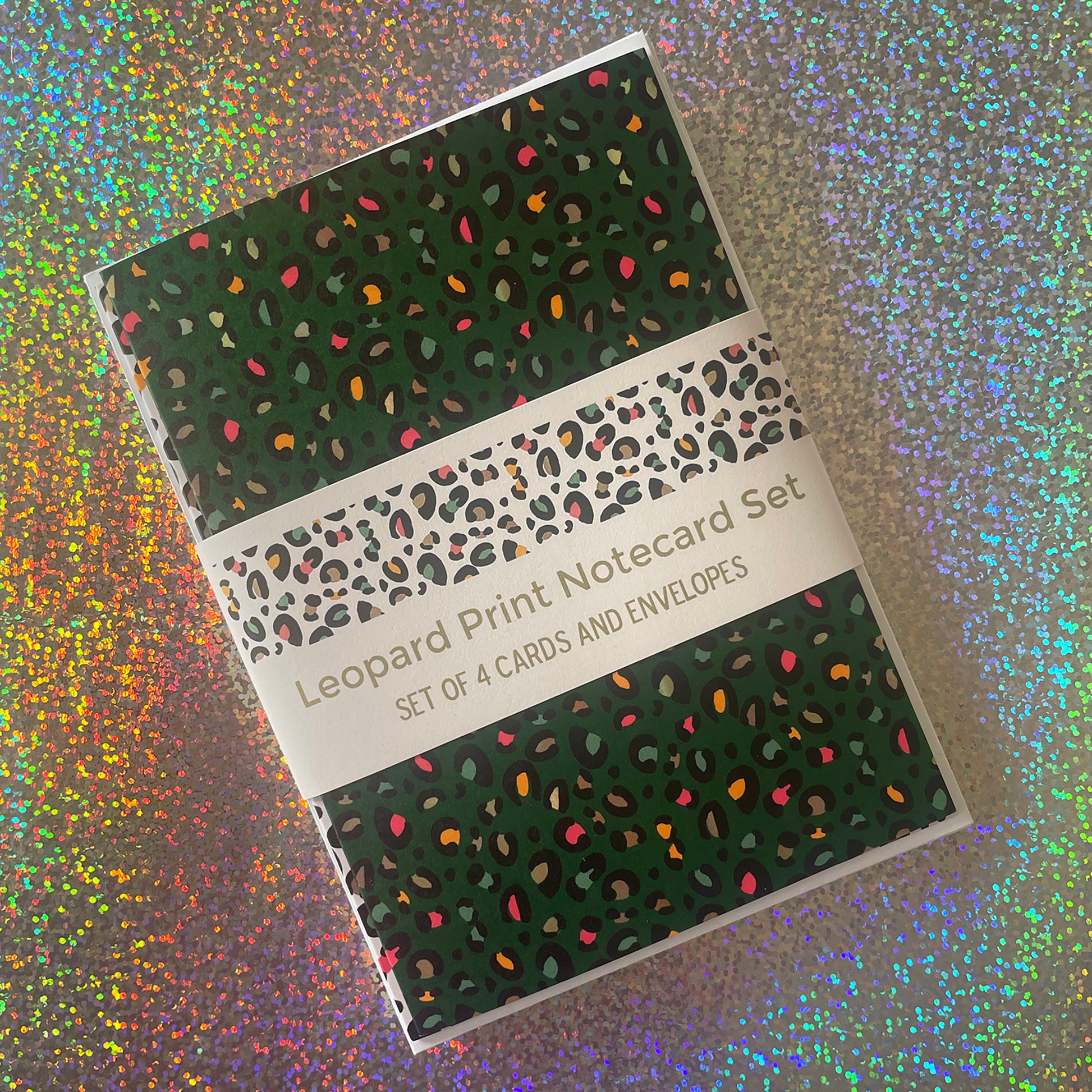 Image shows a set of 4 leopard print notecards each in a different fun colour with pops of neon in the pattern