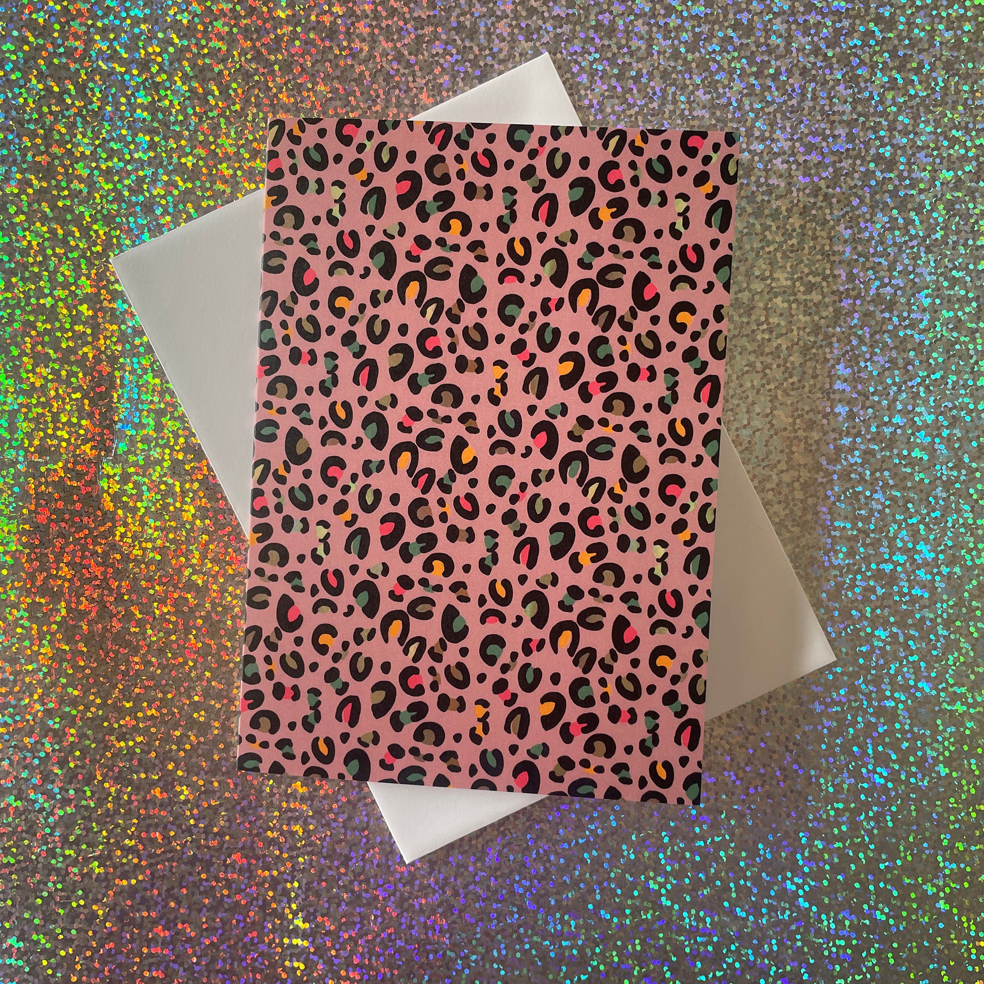 Image shows a set of 4 leopard print notecards each in a different fun colour with pops of neon in the pattern