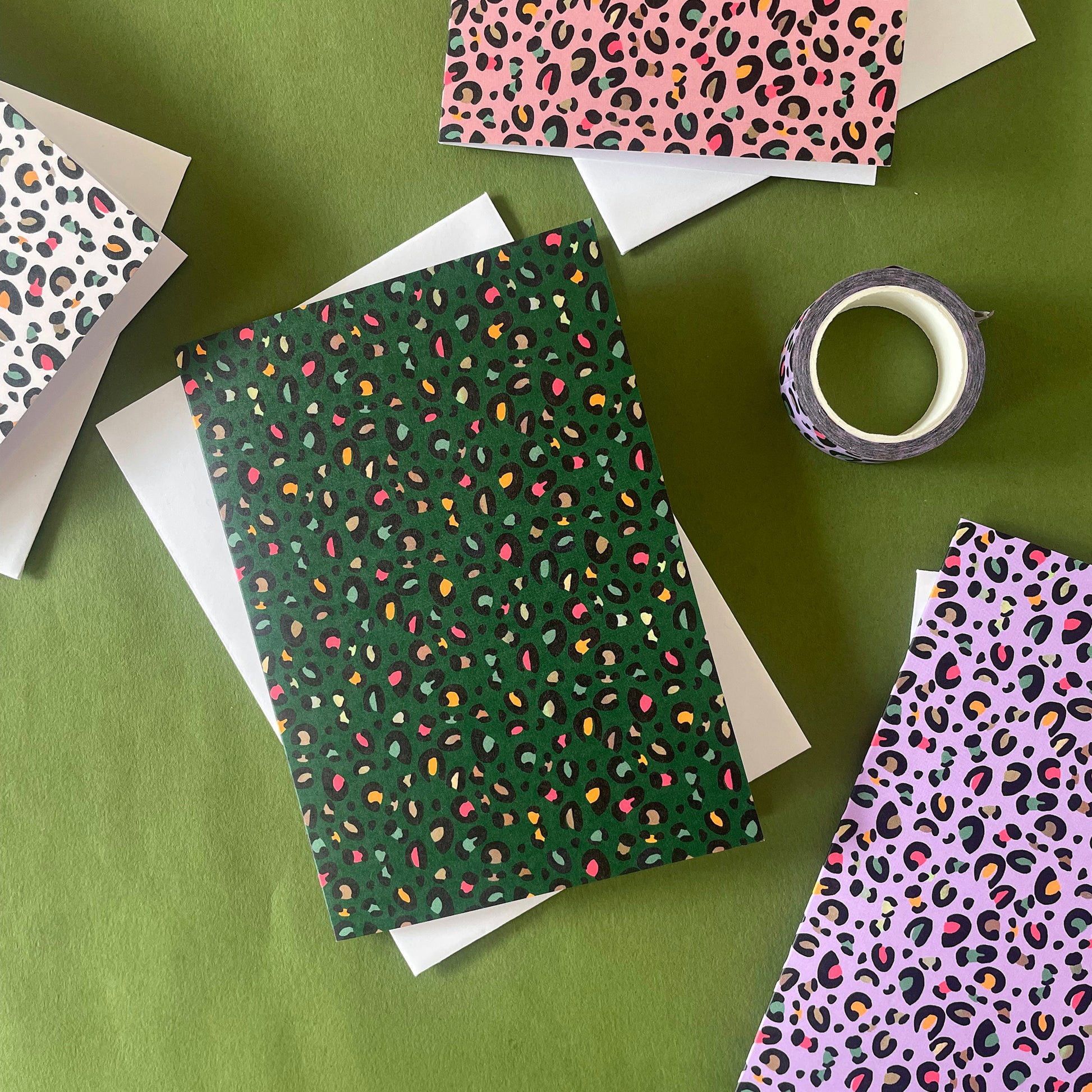 Image shows a set of 4 leopard print notecards each in a different fun colour with pops of neon in the pattern