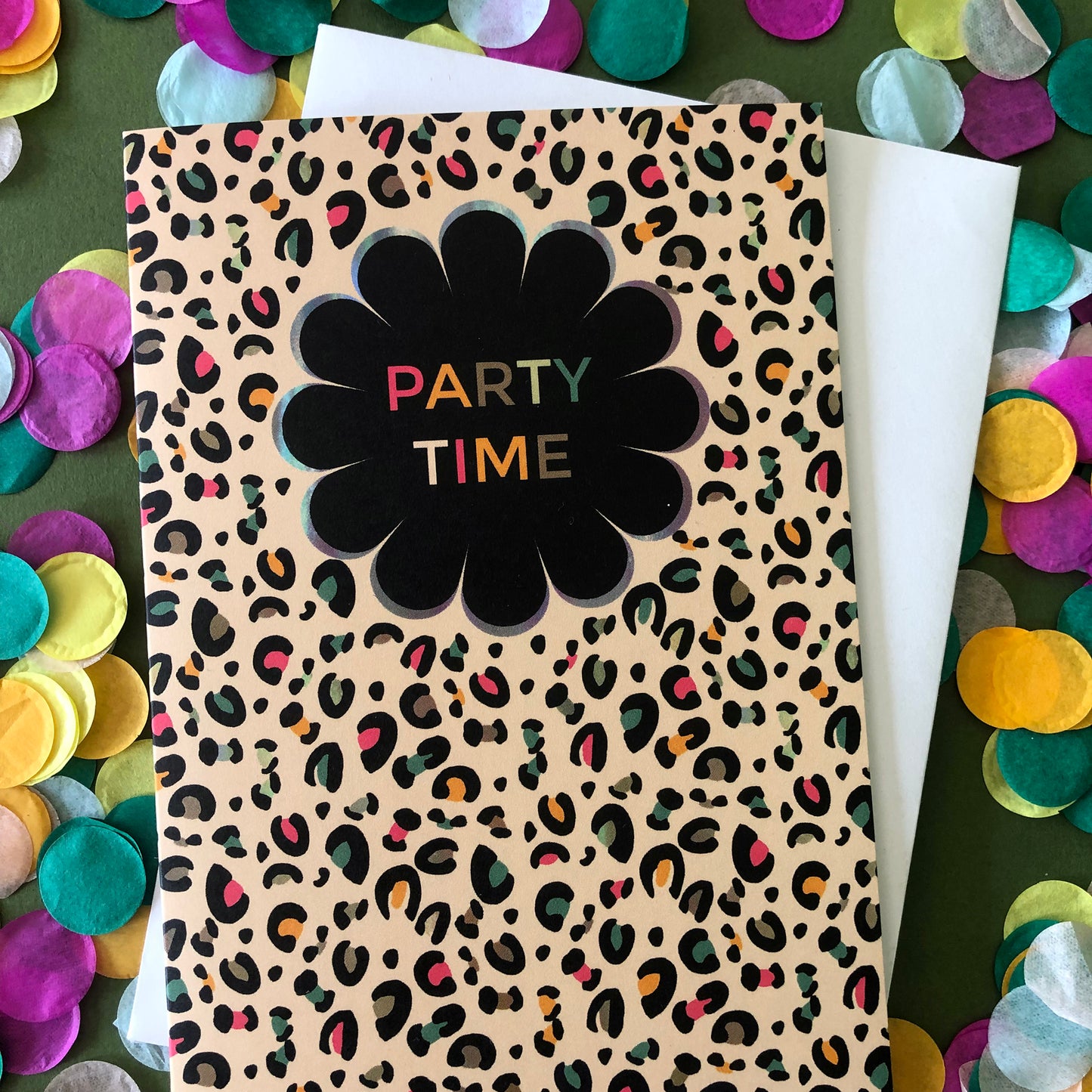 Fun greetings card that says 'Party Time' in a black flower shape with pale gold leopard print background with pops of neon.