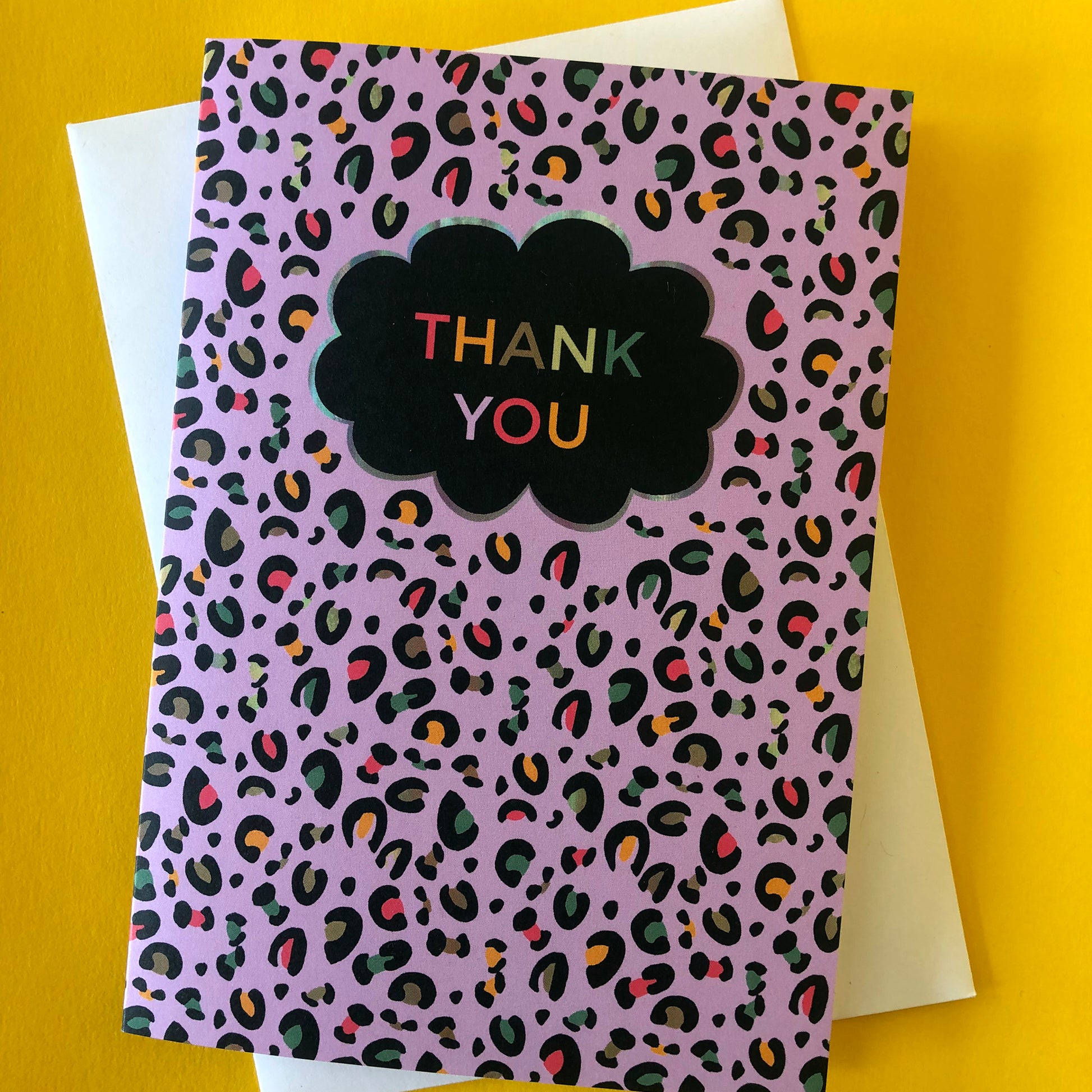 Image of a leopard Print Thank you card with lilac print and pops of neon.